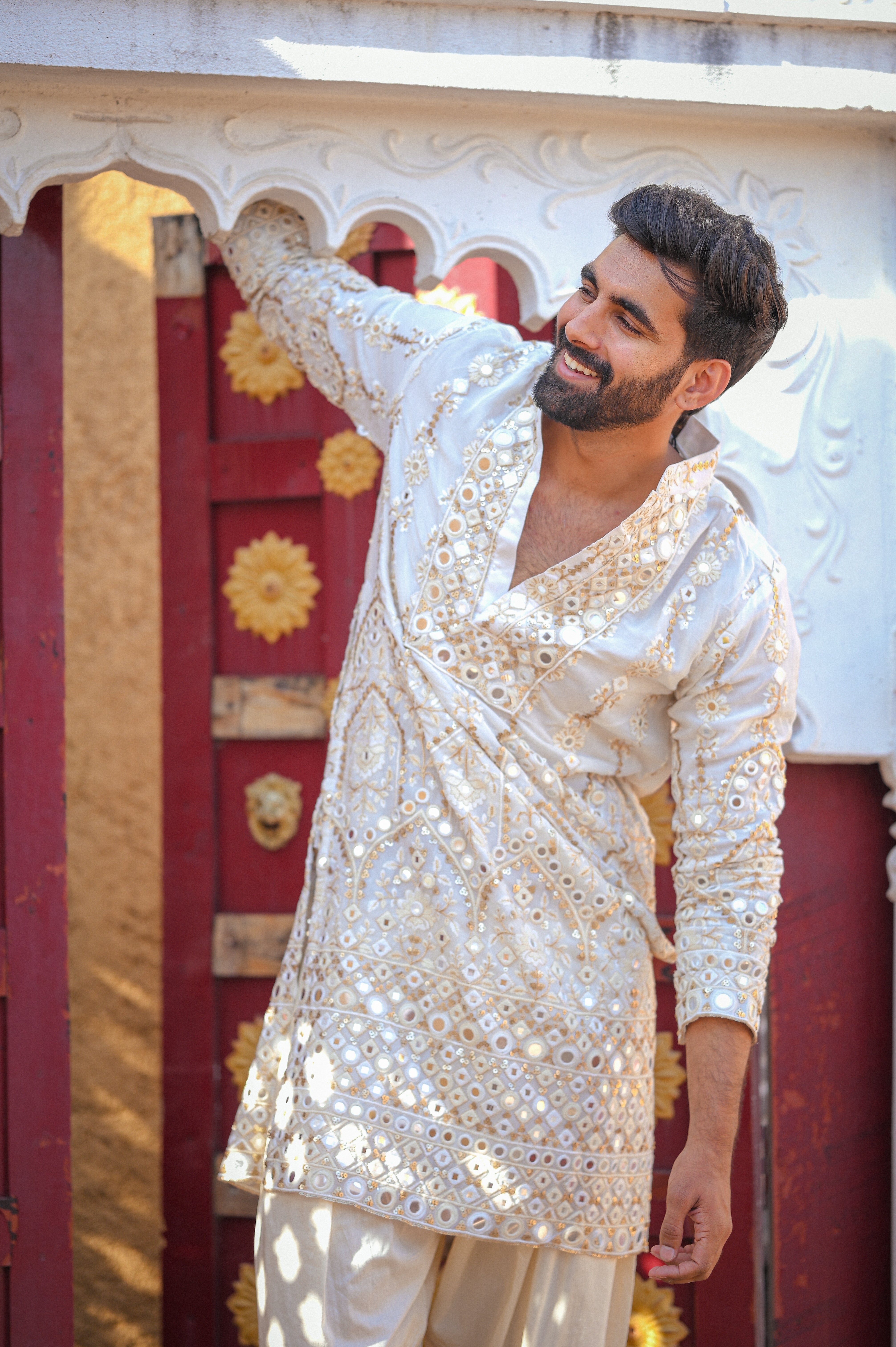 Cream mirror work kurta with detailed neckline and ghera with gold zari highlighting.