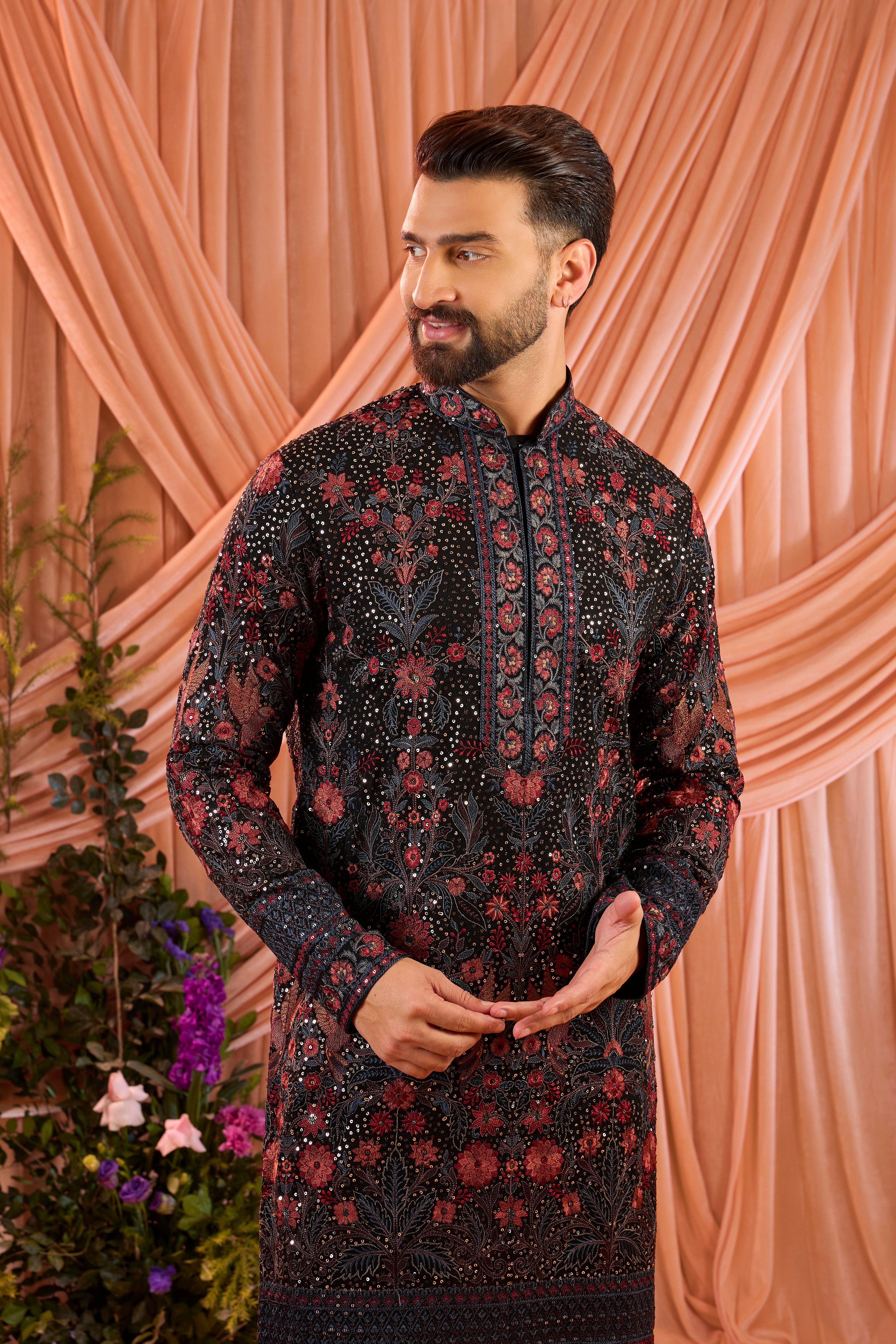 A black kurta elevated with heavy sequin work and intricate flora and fauna embroidery throughout.