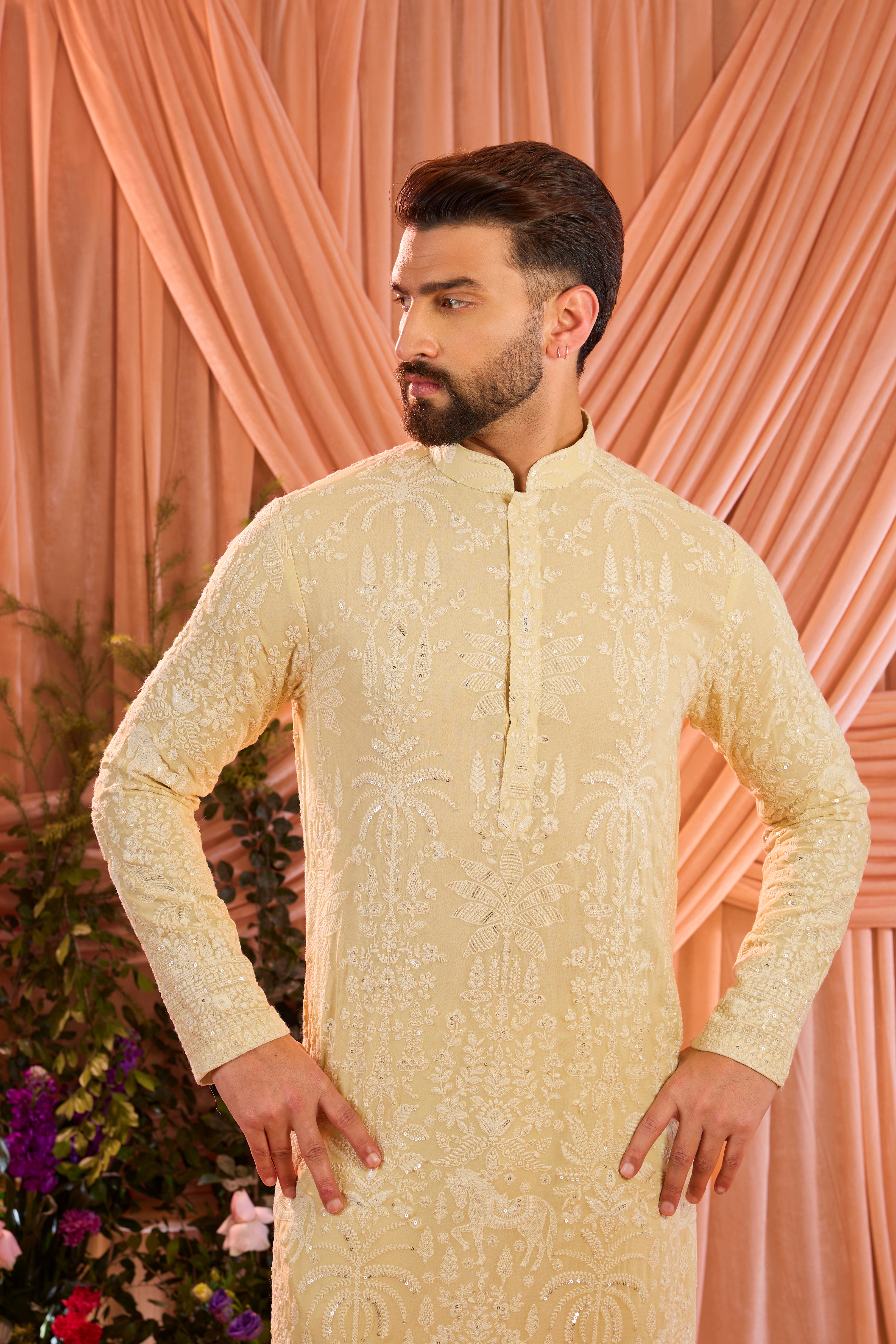 A pastel yellow kurta illuminated with delicate sequins, brought to life by intricate flora and fauna embroidery.