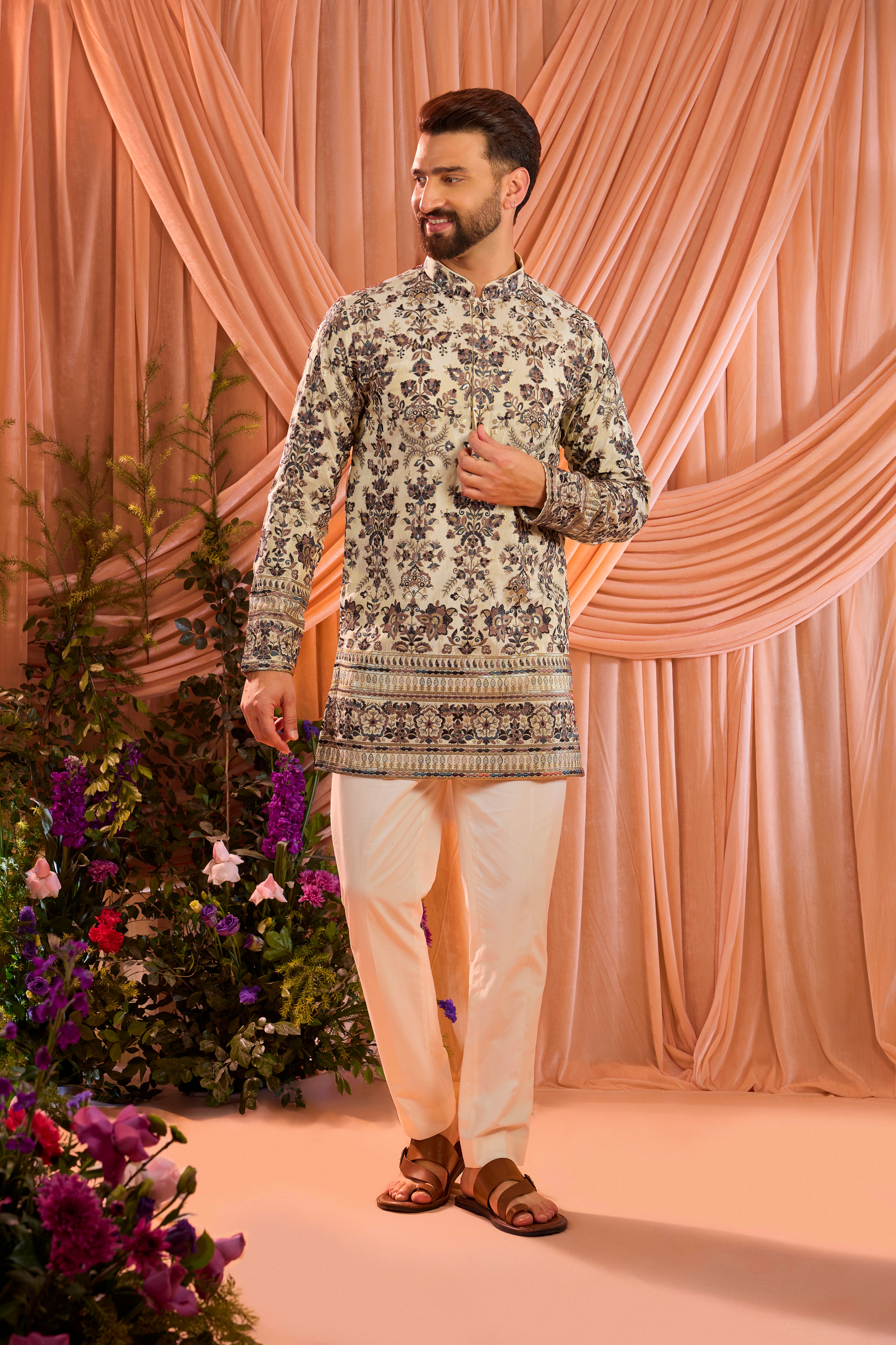 A light golden short floral chikankari kurta accented with delicate multi threadwork, enriched by zari and subtle sequin detailing.