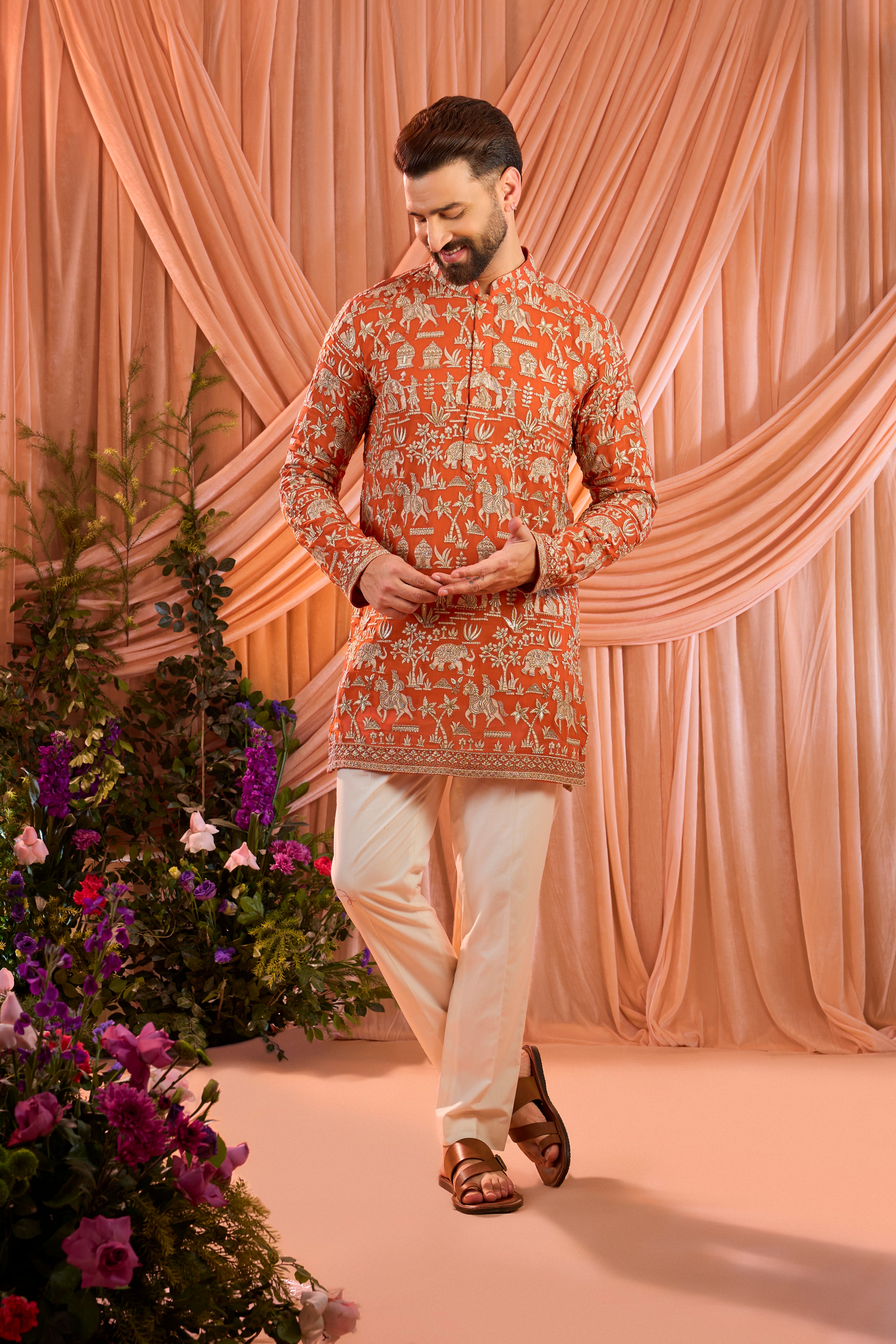 Orange pink royal-heritage kurta adorned with intricately detailed Mughal-era motifs, reflecting the grandeur of imperial artistry.