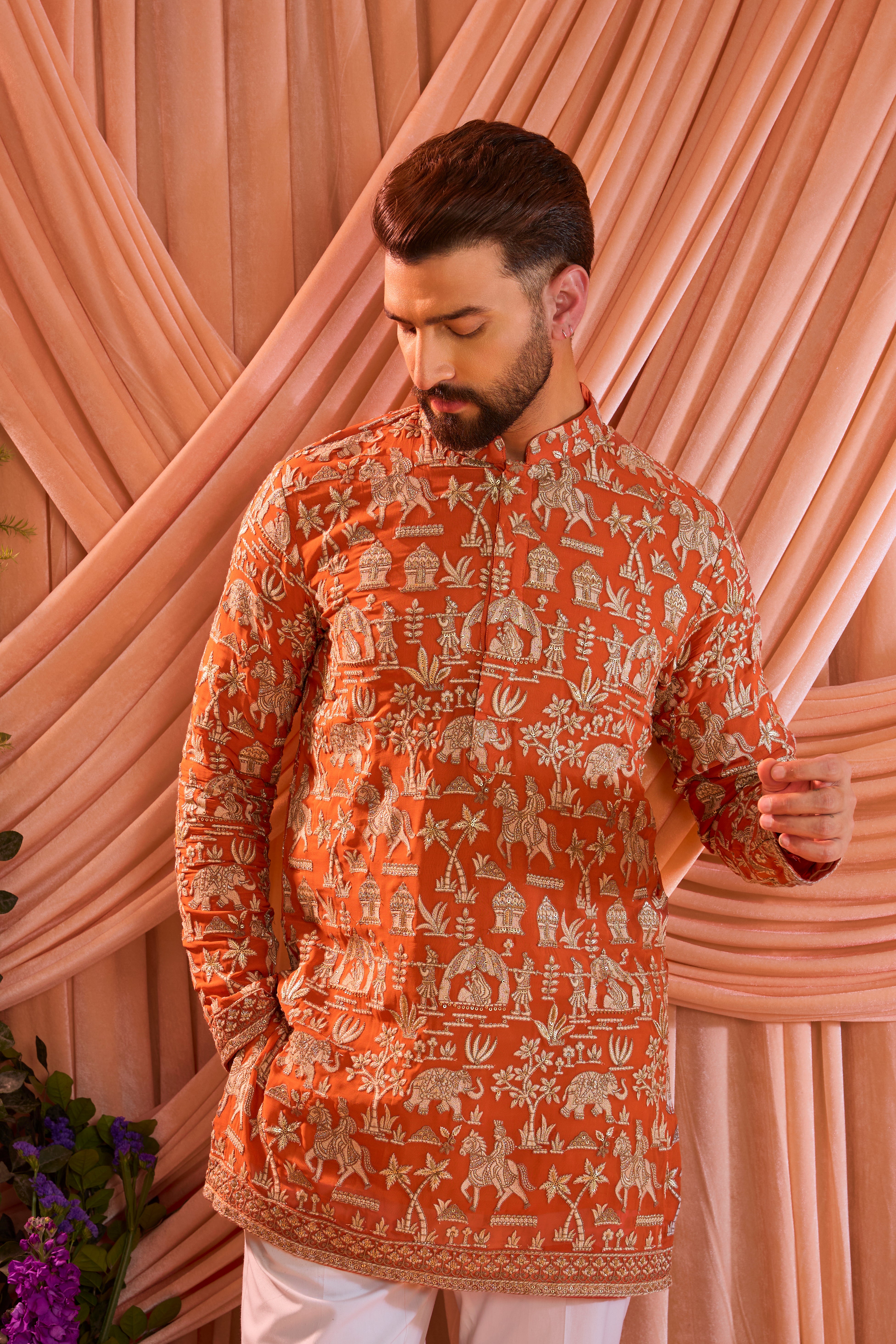 Orange pink royal-heritage kurta adorned with intricately detailed Mughal-era motifs, reflecting the grandeur of imperial artistry.