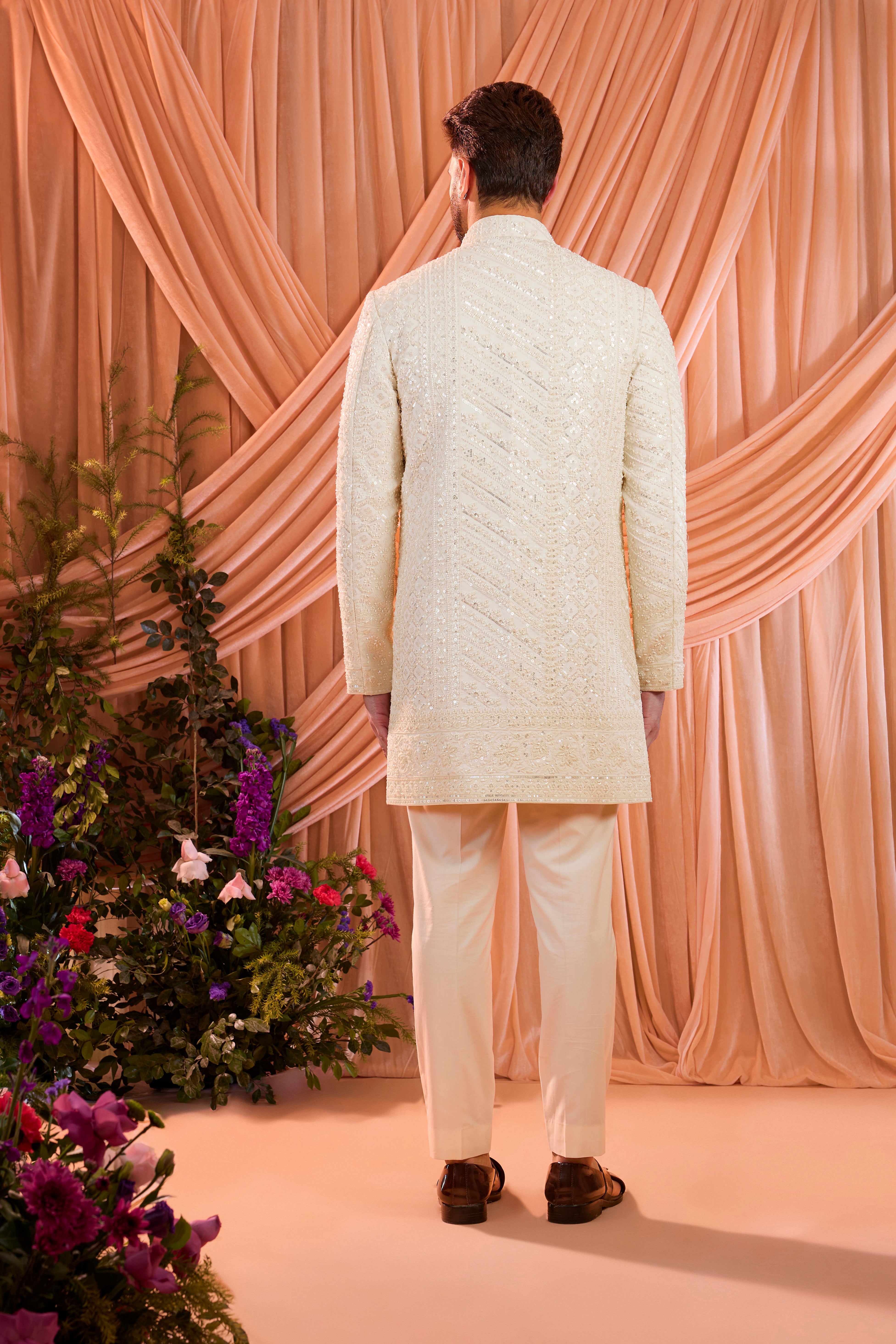 An ivory hand-embroidered formal short sherwani, exquisitely adorned with intricate ivory cut-dana detailing