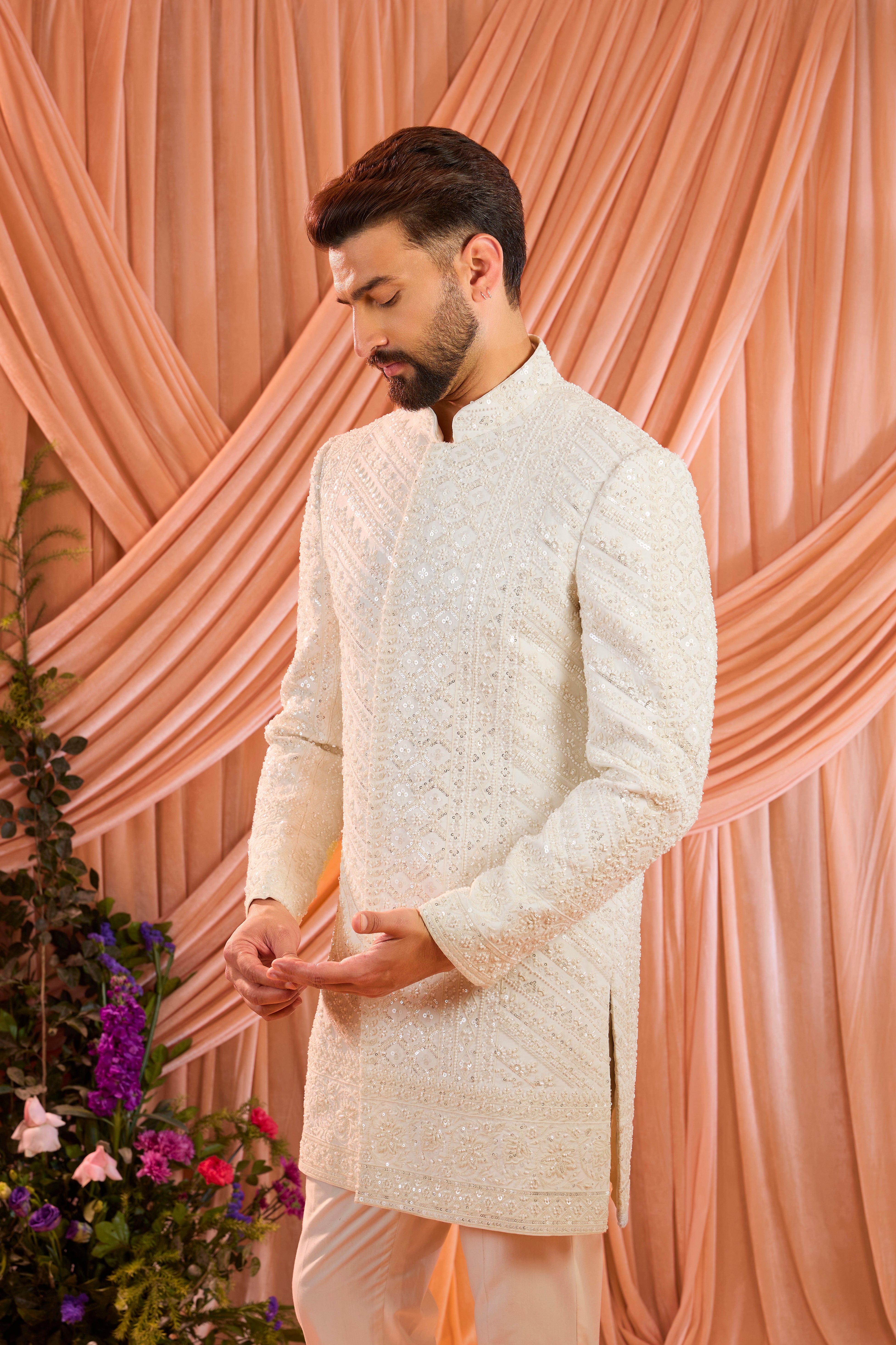 An ivory hand-embroidered formal short sherwani, exquisitely adorned with intricate ivory cut-dana detailing