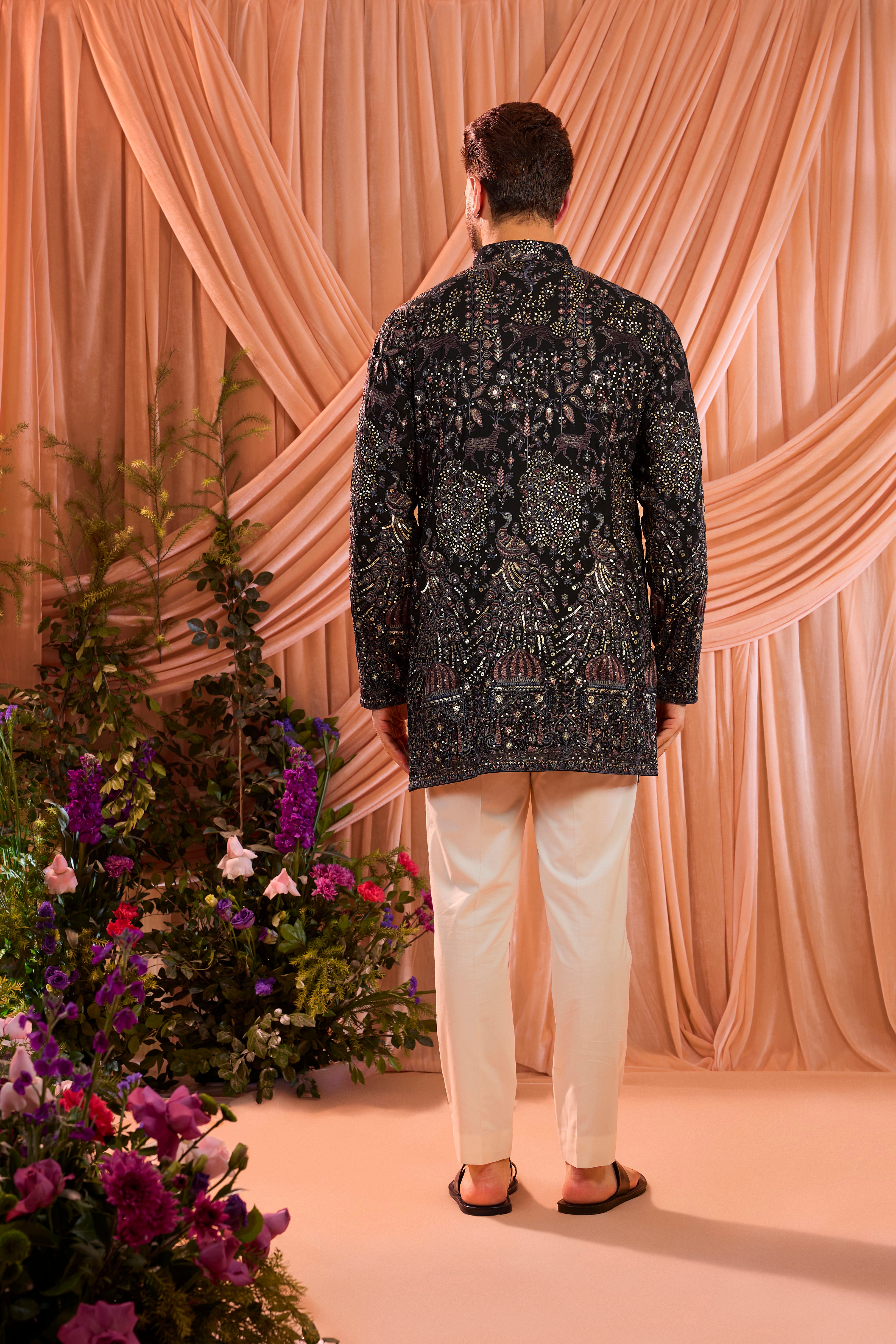 A blue/multi coloured royal heritage kurta adorned with detailed flora and fauna motifs and intricate darbar scenes.