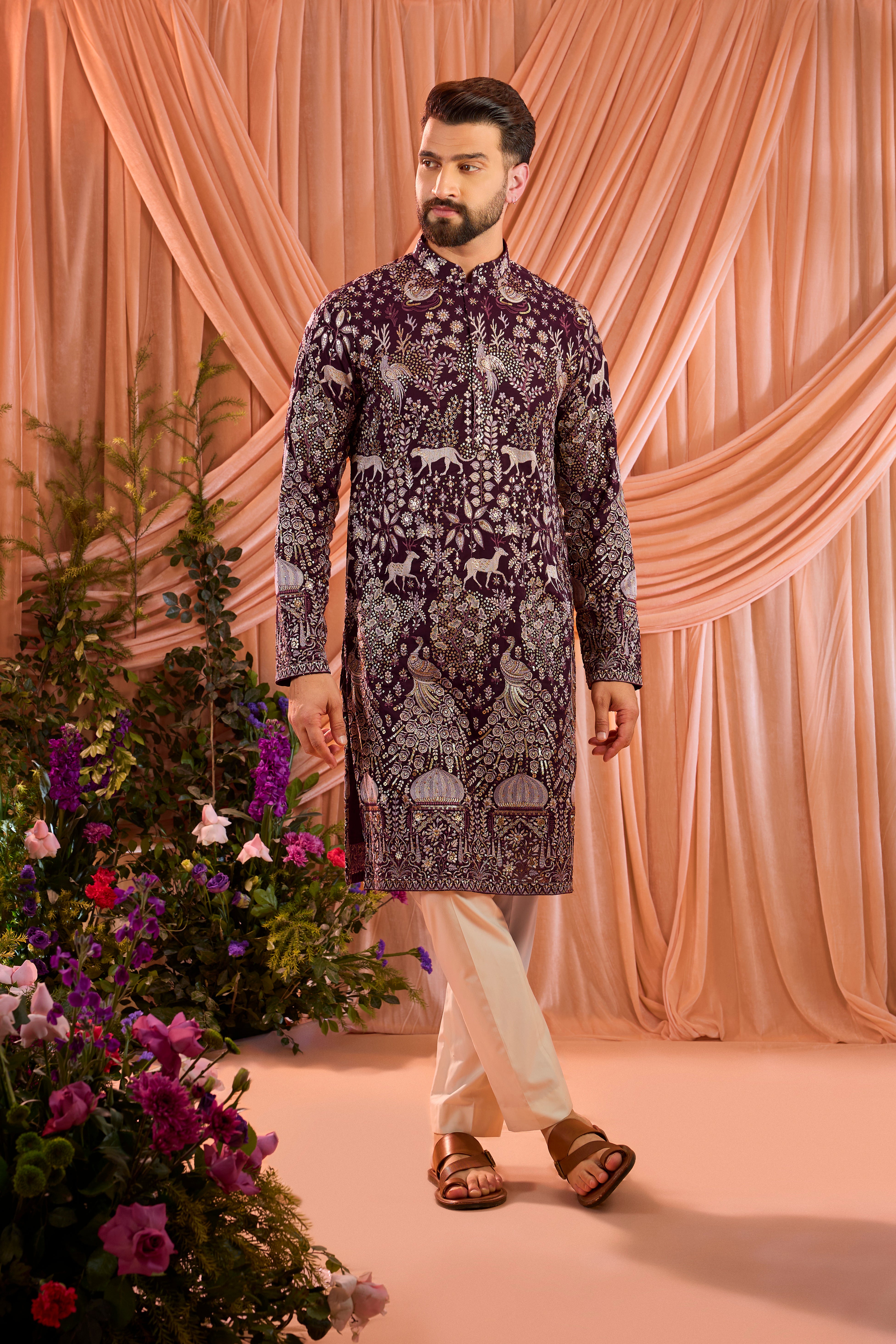 A wine royal-heritage kurta adorned with detailed flora and fauna motifs and intricate darbar scenes.