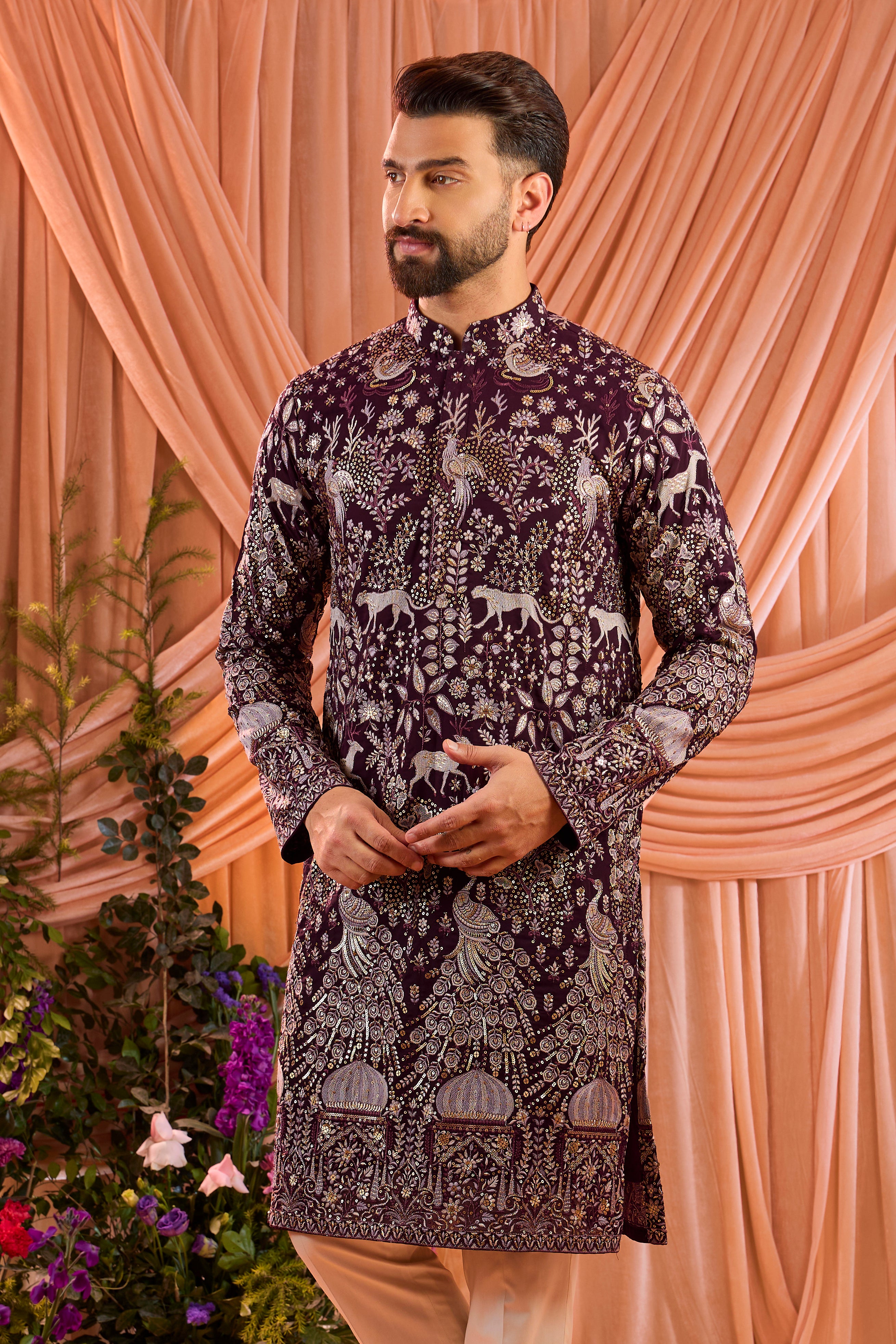 A wine royal-heritage kurta adorned with detailed flora and fauna motifs and intricate darbar scenes.