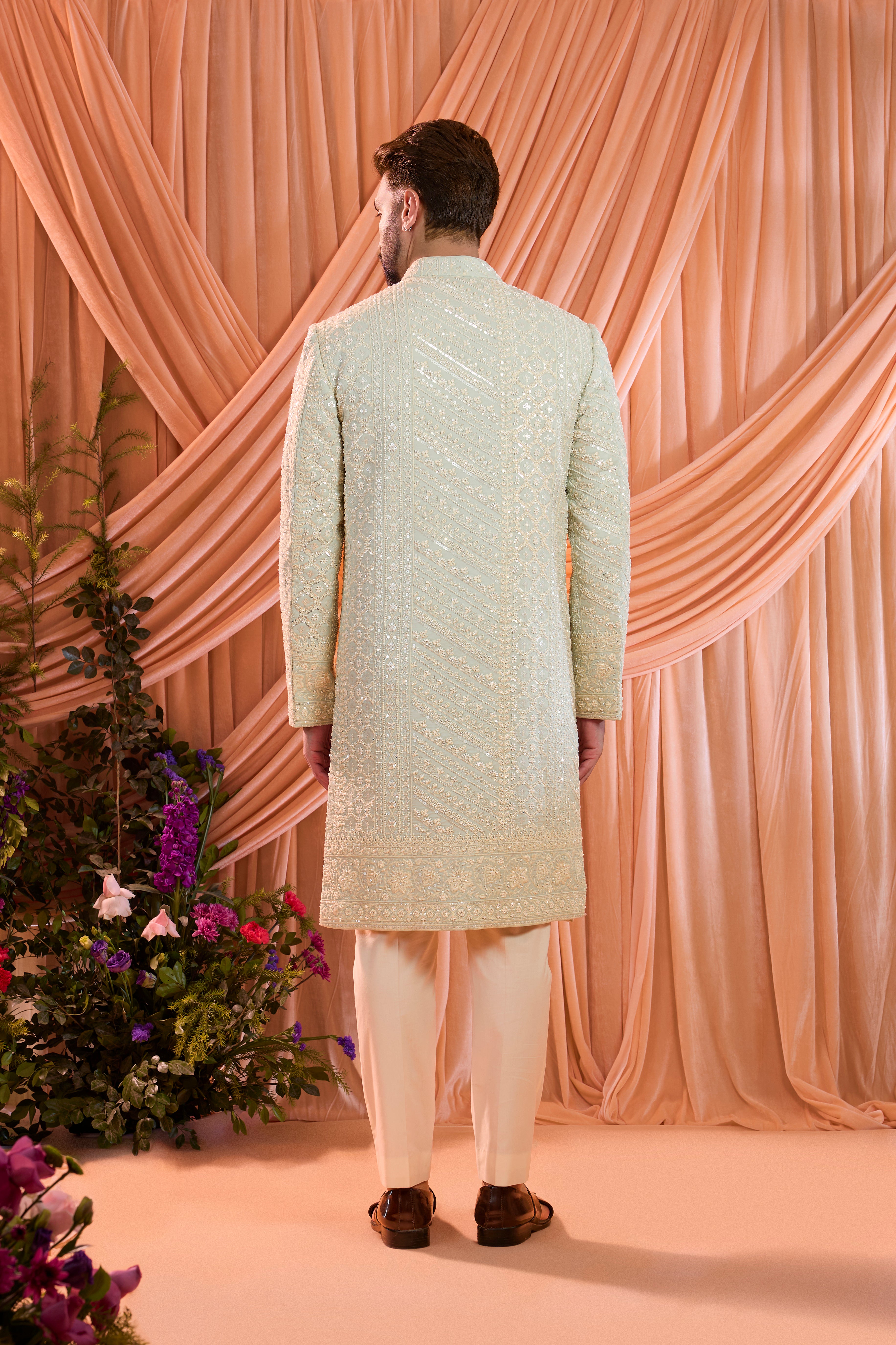 An aqua blue hand-embroidered formal sherwani, exquisitely adorned with intricate ivory cut-dana detailing