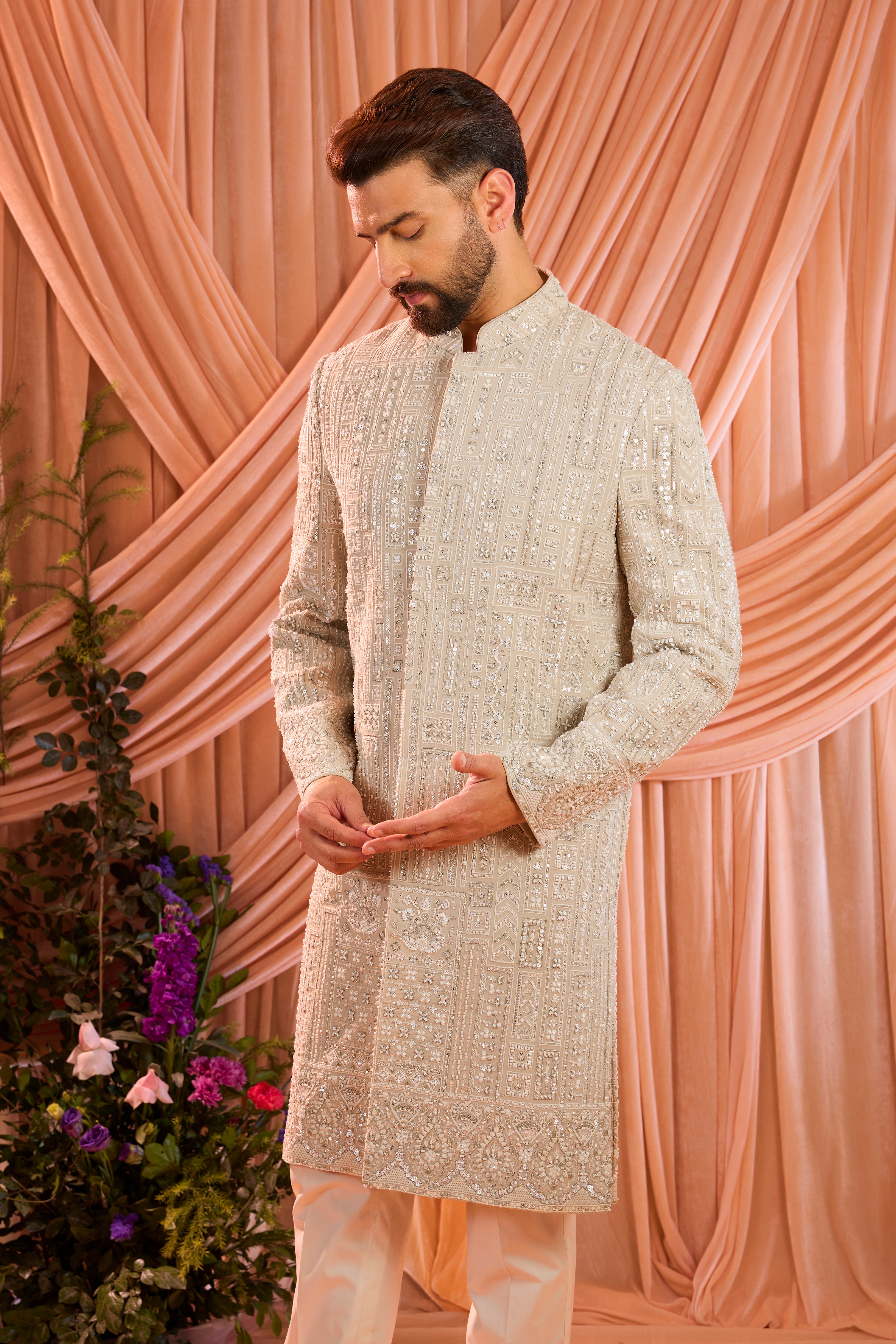 A mouse brown hand-embroidered formal sherwani, exquisitely adorned with intricate ivory cut-dana detailing.