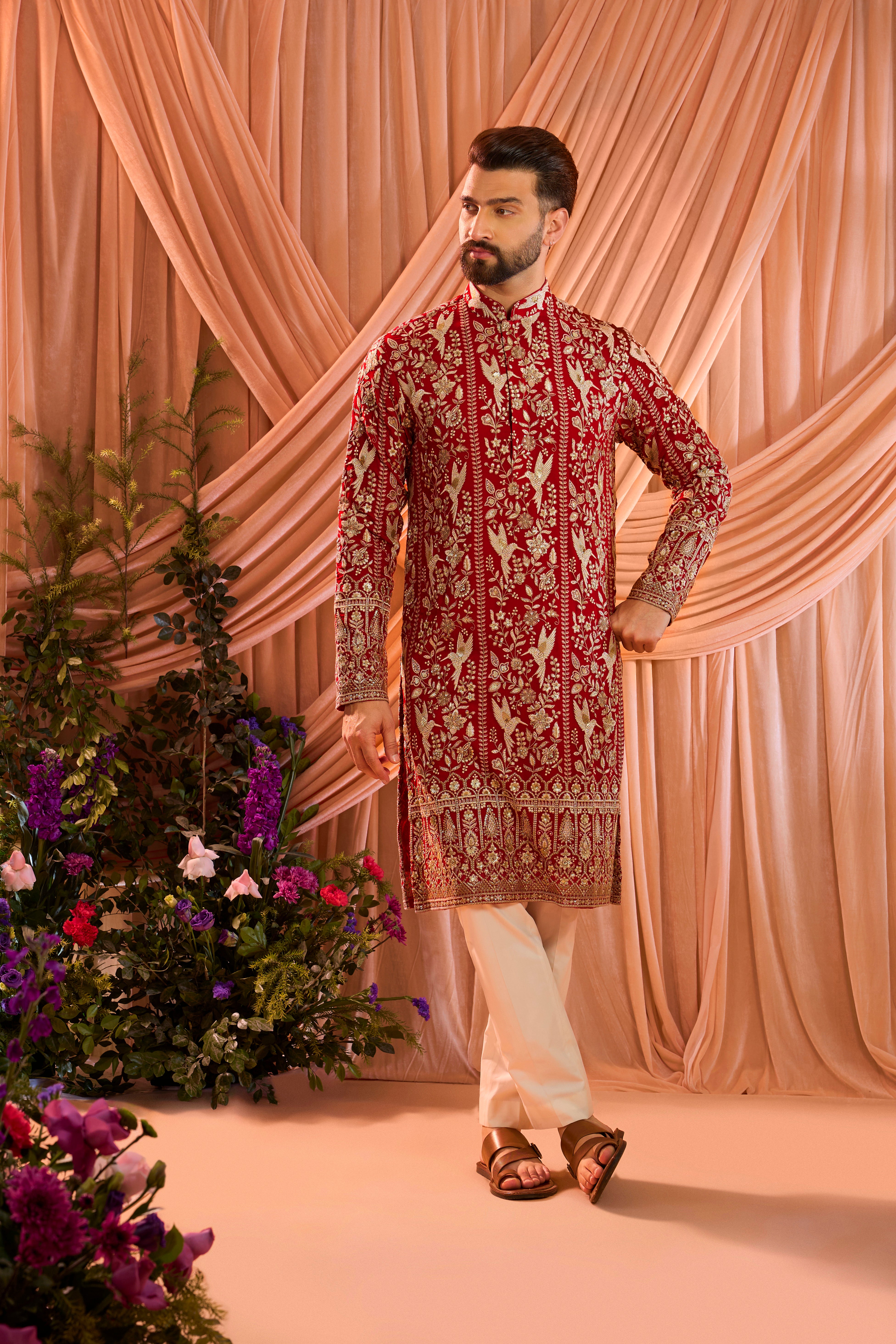 A hot pink chikankari kurta adorned with intricate flora and fauna motifs, reflecting refined artisanal craftsmanship.