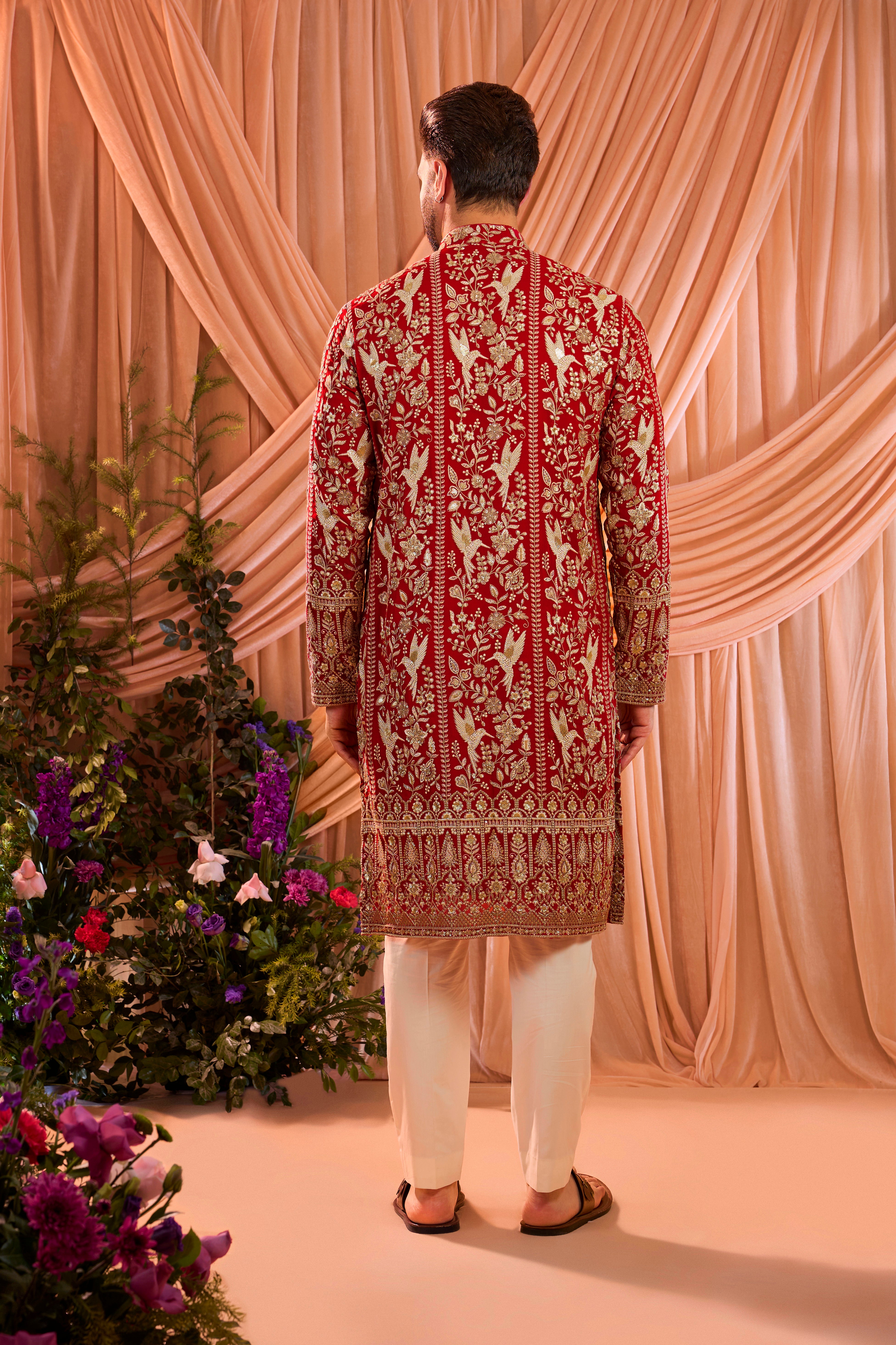 A hot pink chikankari kurta adorned with intricate flora and fauna motifs, reflecting refined artisanal craftsmanship.