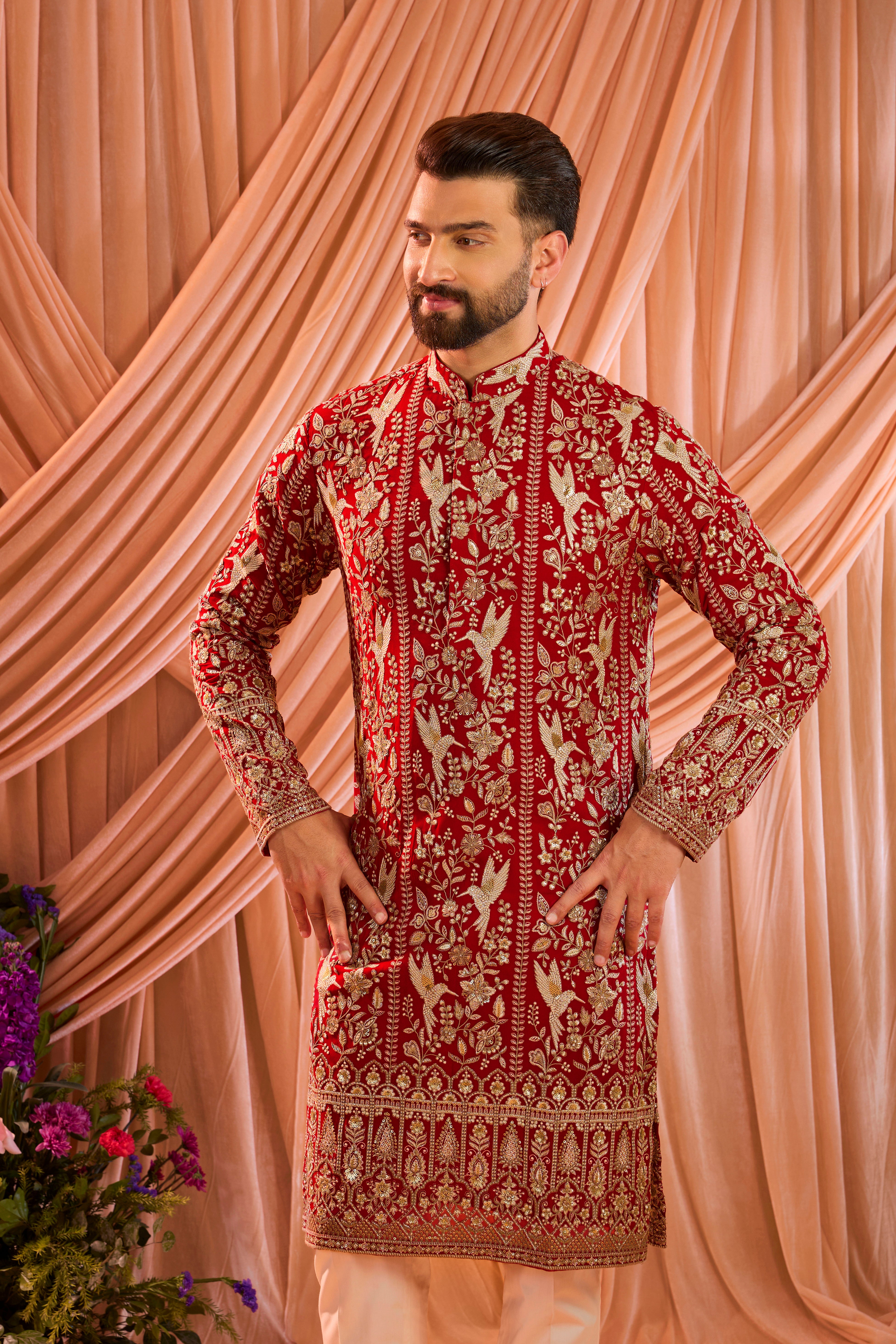A hot pink chikankari kurta adorned with intricate flora and fauna motifs, reflecting refined artisanal craftsmanship.