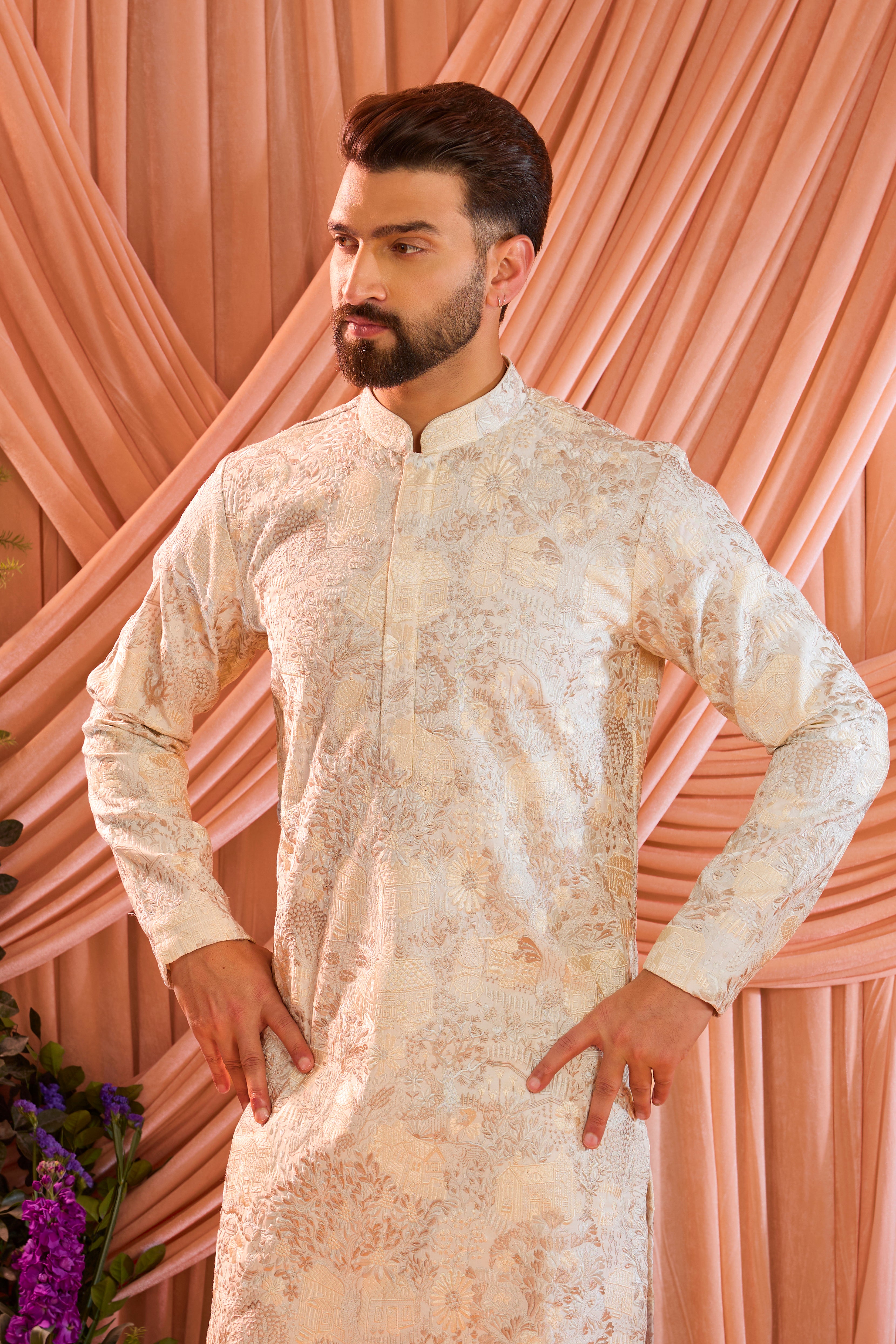 A cream tropical chikankari kurta enriched with intricate threadwork and detailed floral motifs, inspired by a vintage homes era.