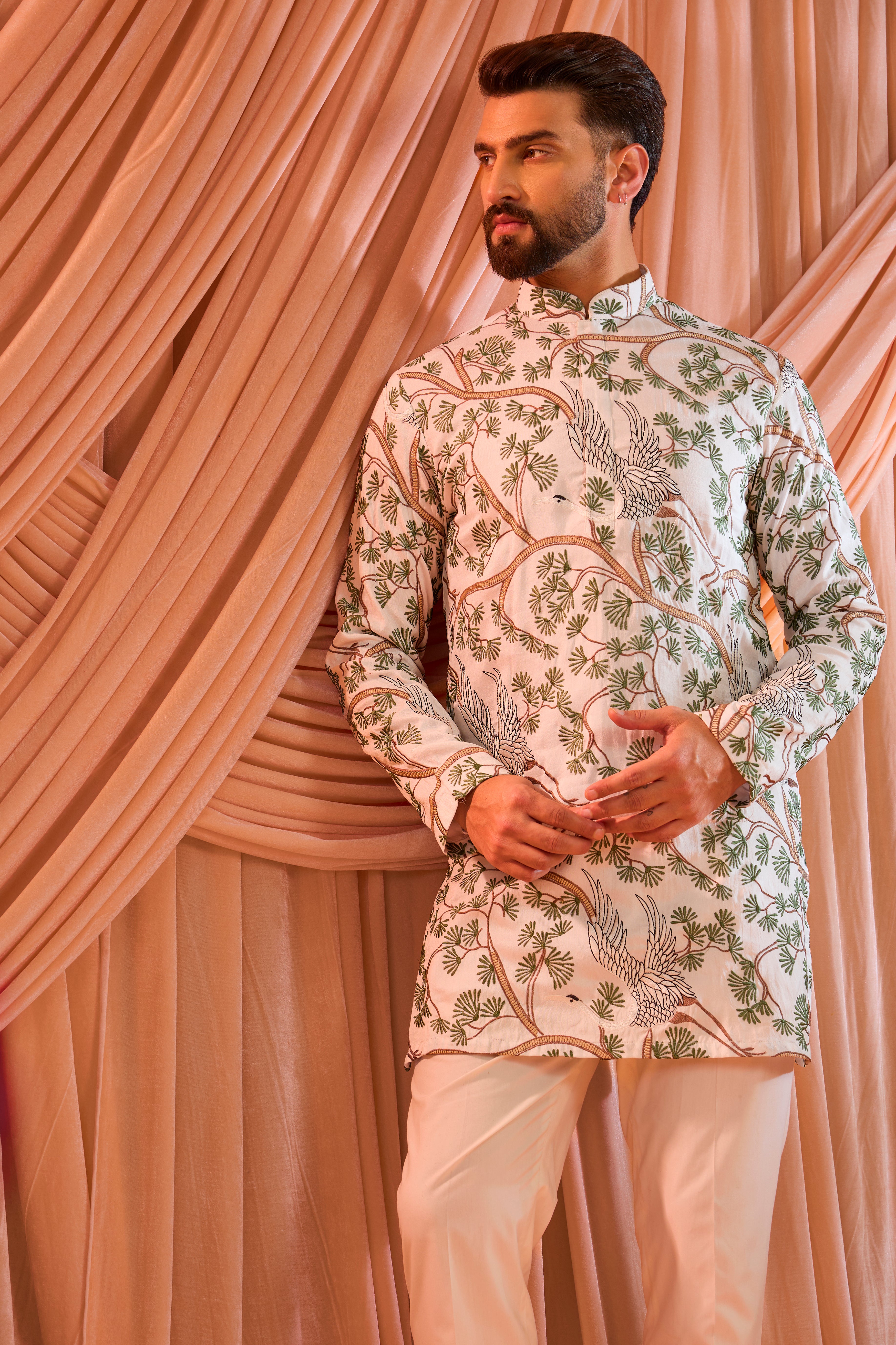 An ivory short kurta featuring a beautifully rendered tropical backdrop, highlighted by serene flamingo motifs.