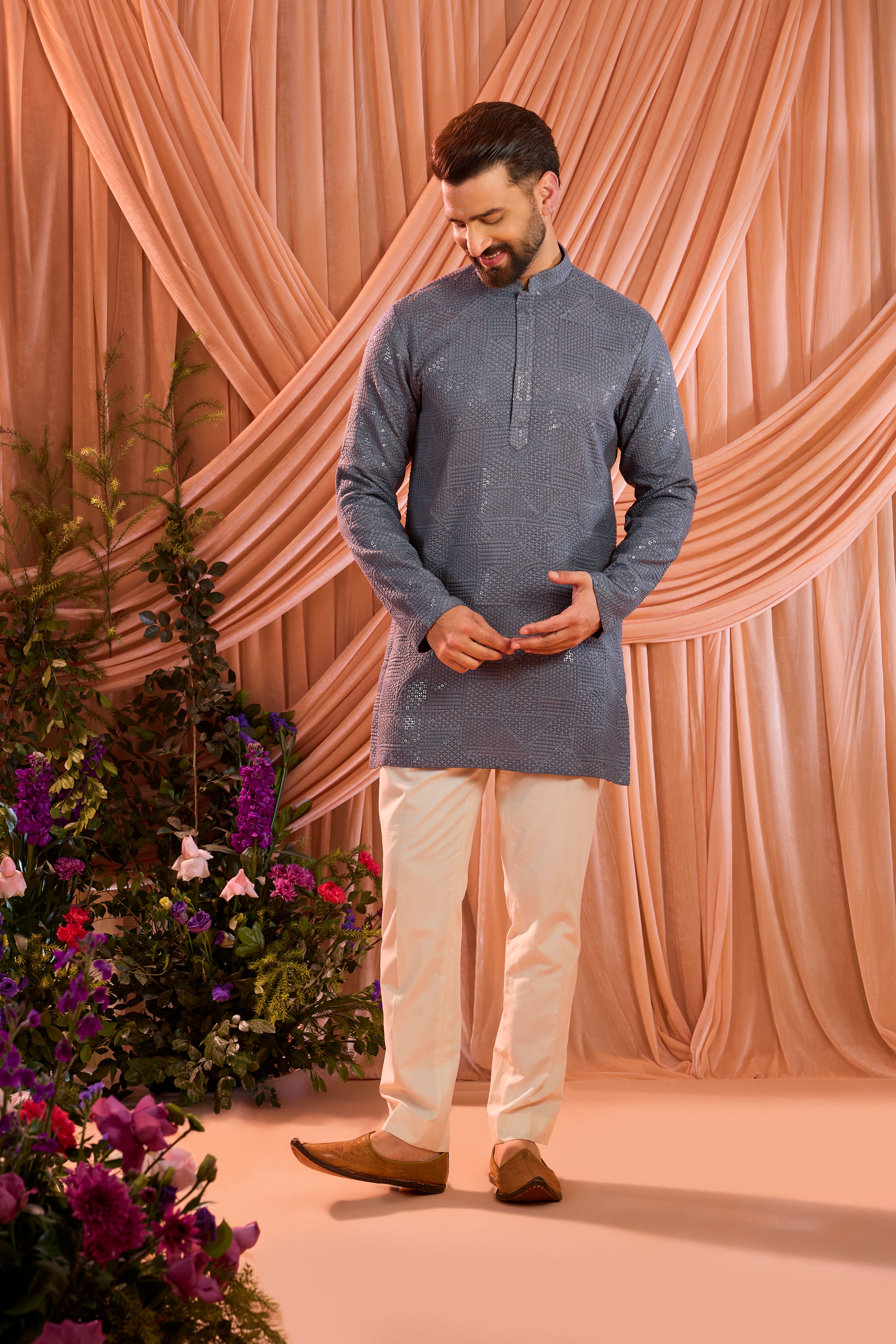 A slate grey kurta elevated with heavy sequin embellishment arranged in an abstract design.