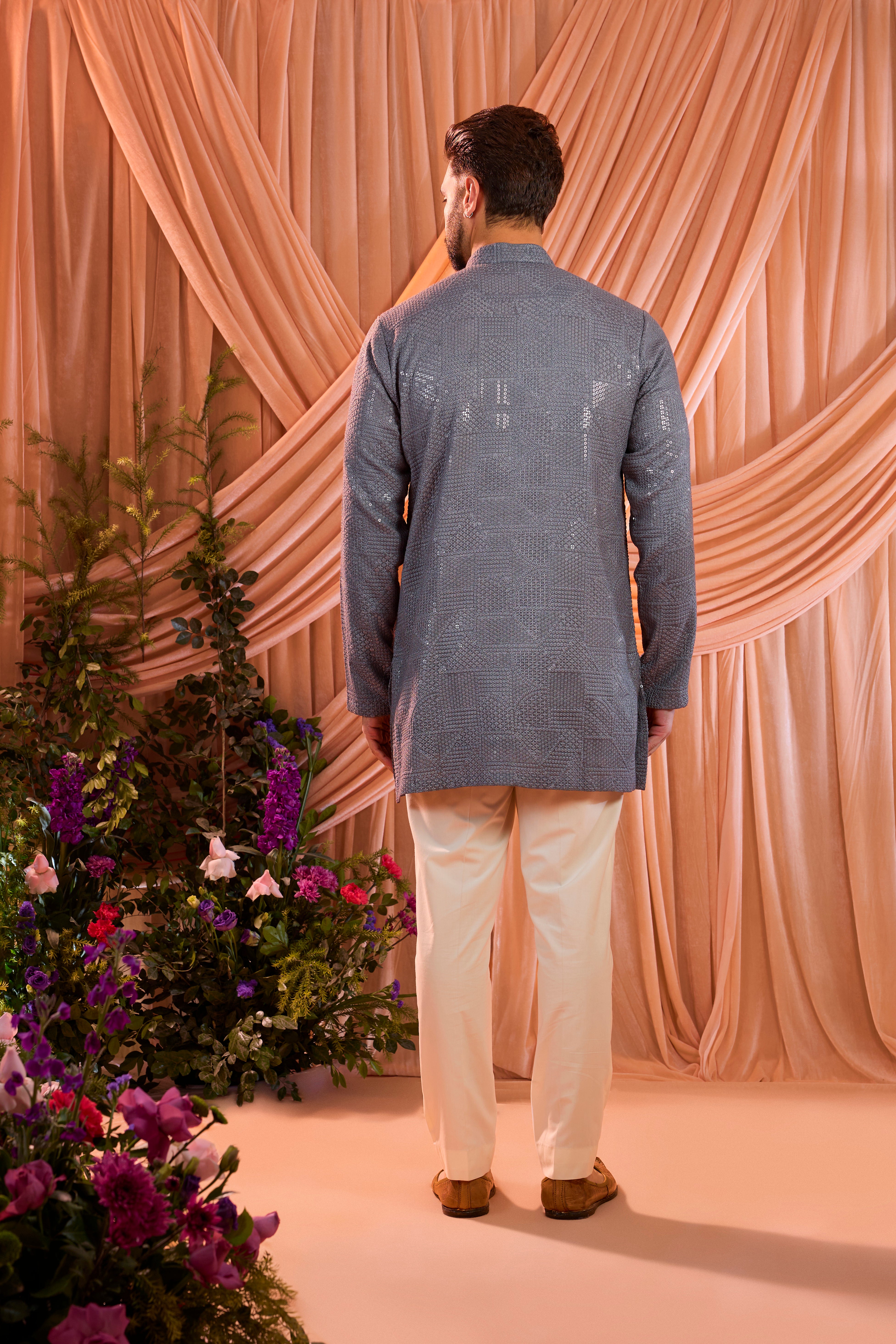 A slate grey kurta elevated with heavy sequin embellishment arranged in an abstract design.