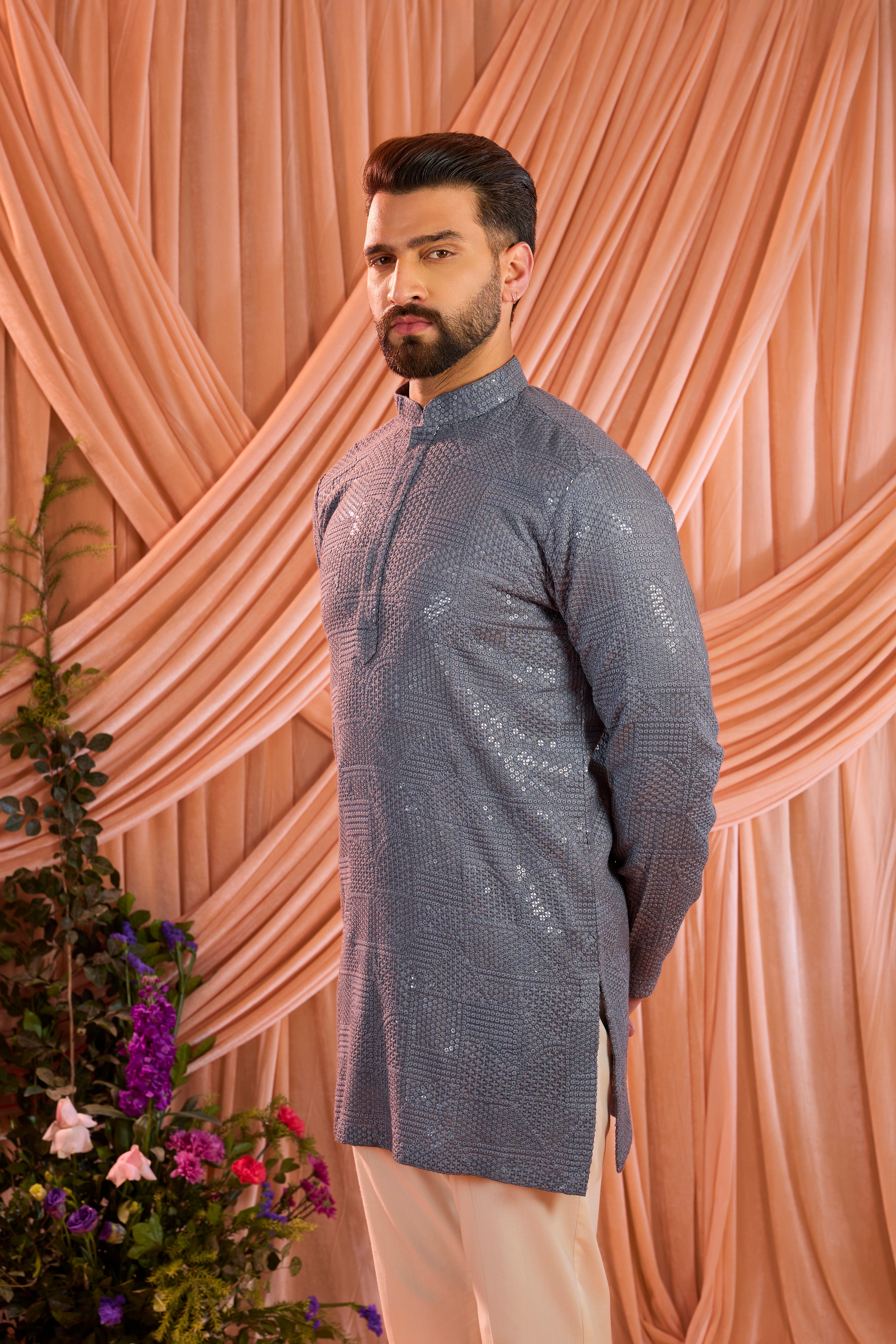 A slate grey kurta elevated with heavy sequin embellishment arranged in an abstract design.