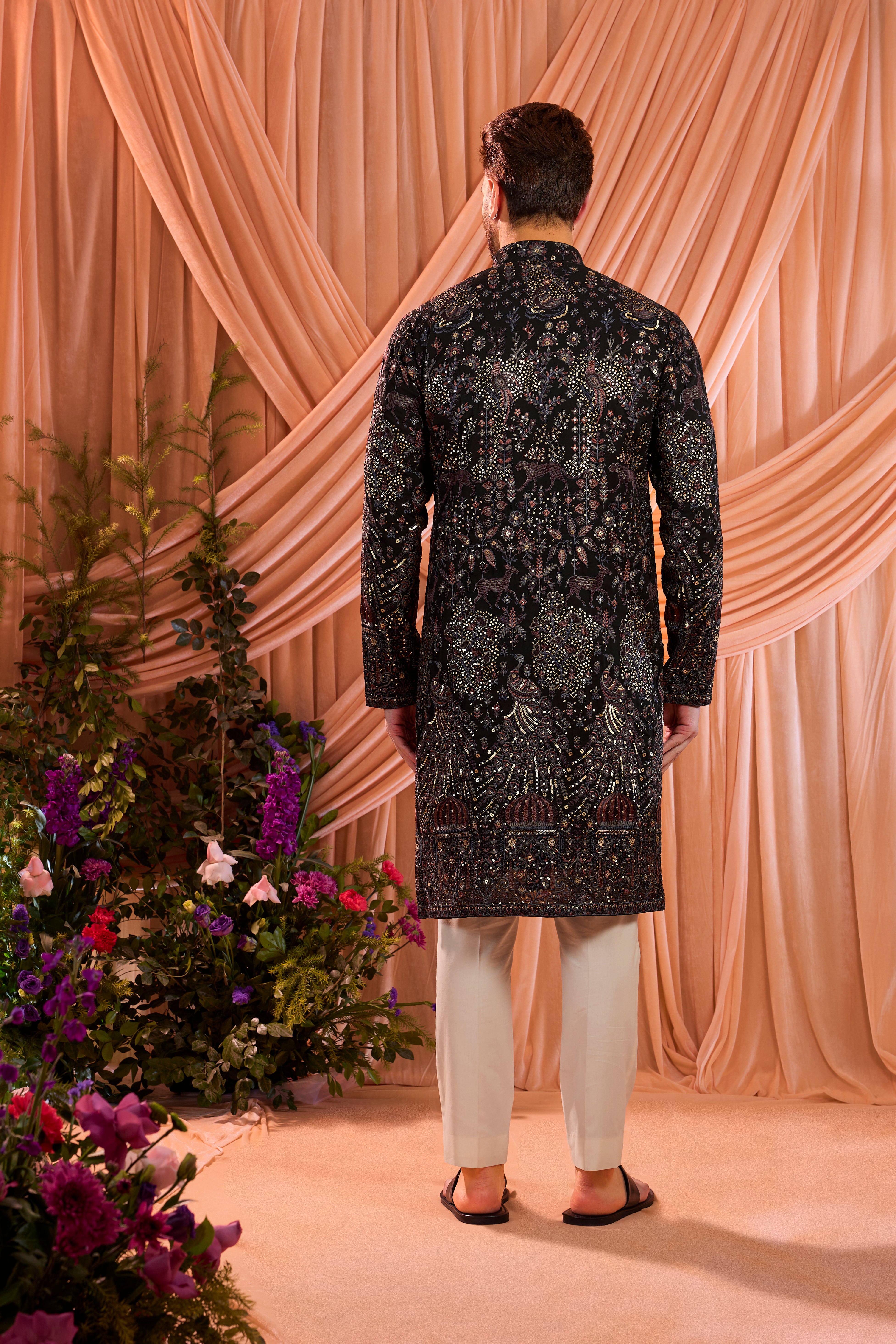 A blue/multi coloured royal heritage kurta adorned with detailed flora and fauna motifs and intricate darbar scenes.