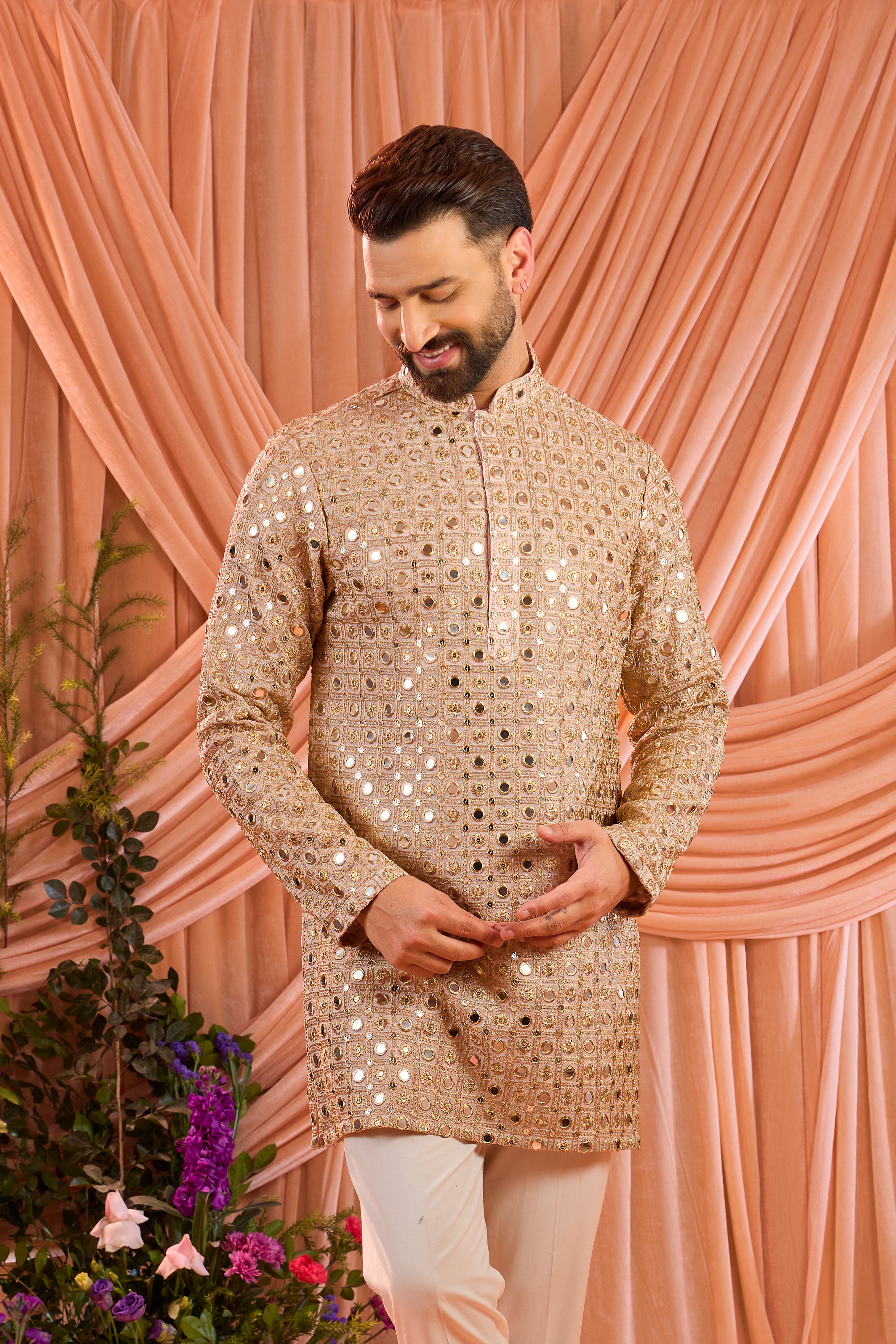 A pink short kurta featuring mirror-inspired sequin work that captures the brilliance of traditional mirror craftsmanship.