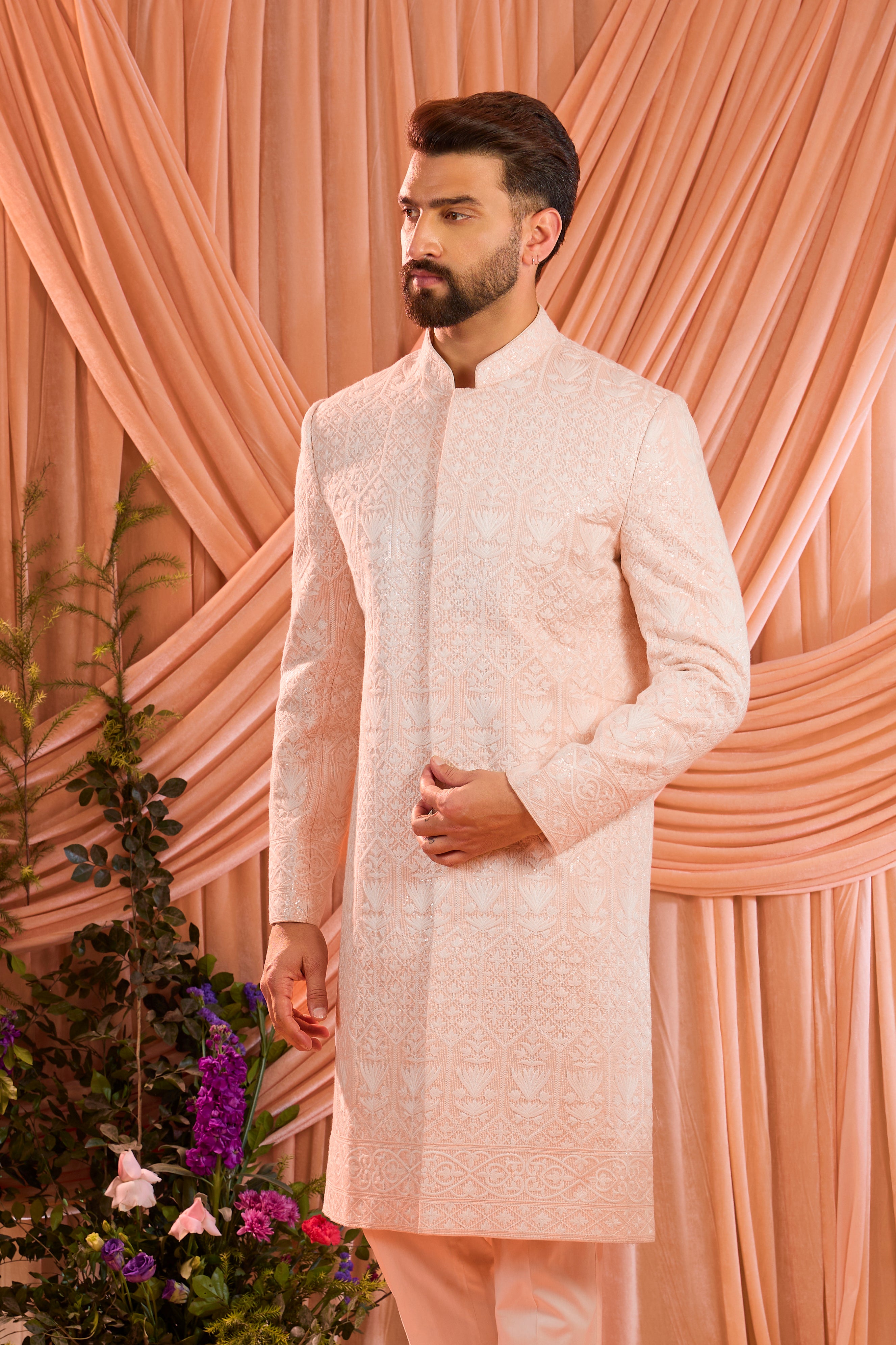 Pink chikankari sherwani distinguished by heavy ivory threadwork and meticulously detailed sequin embellishment