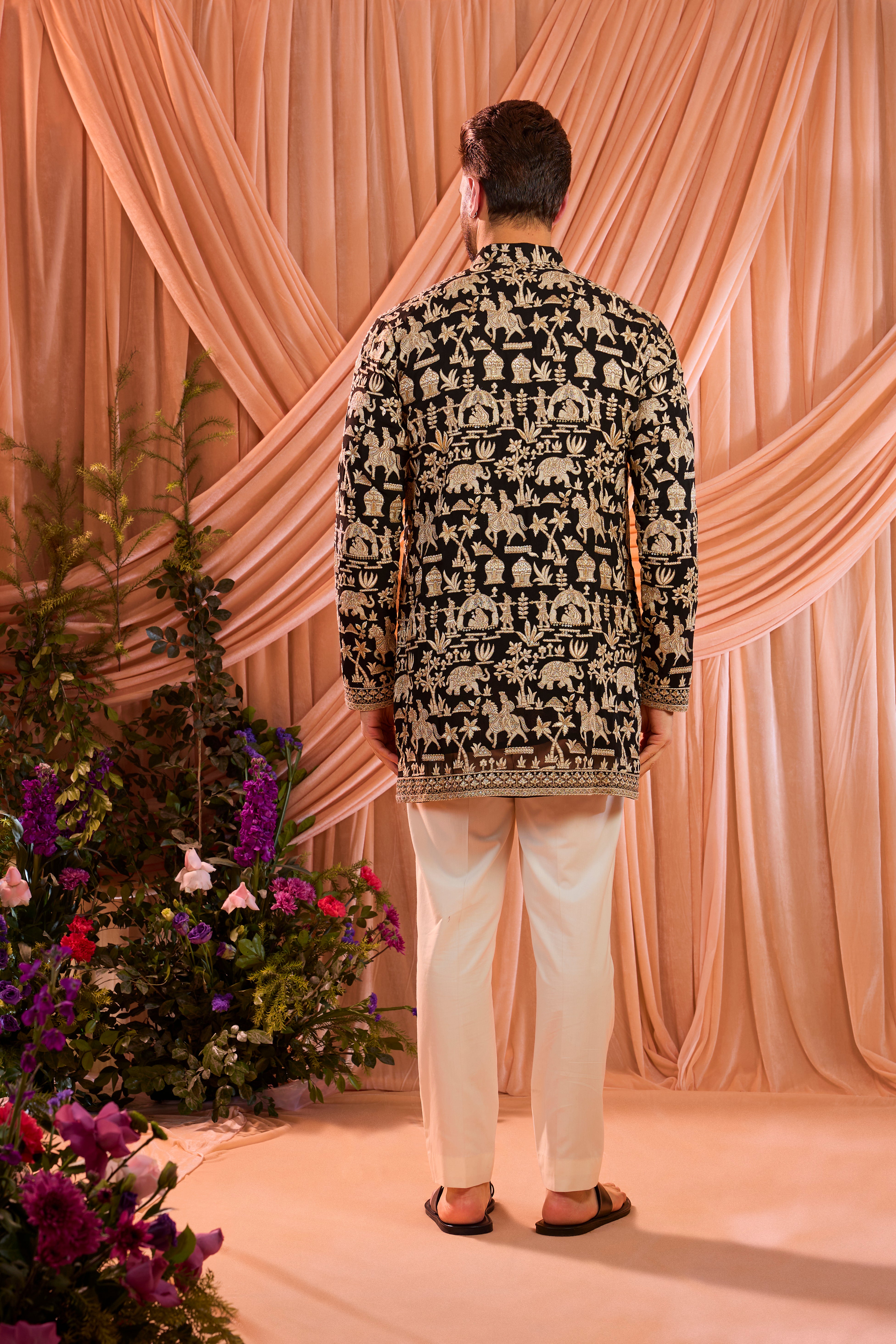 Black royal-heritage kurta adorned with intricately detailed Mughal-era motifs, reflecting the grandeur of imperial artistry.