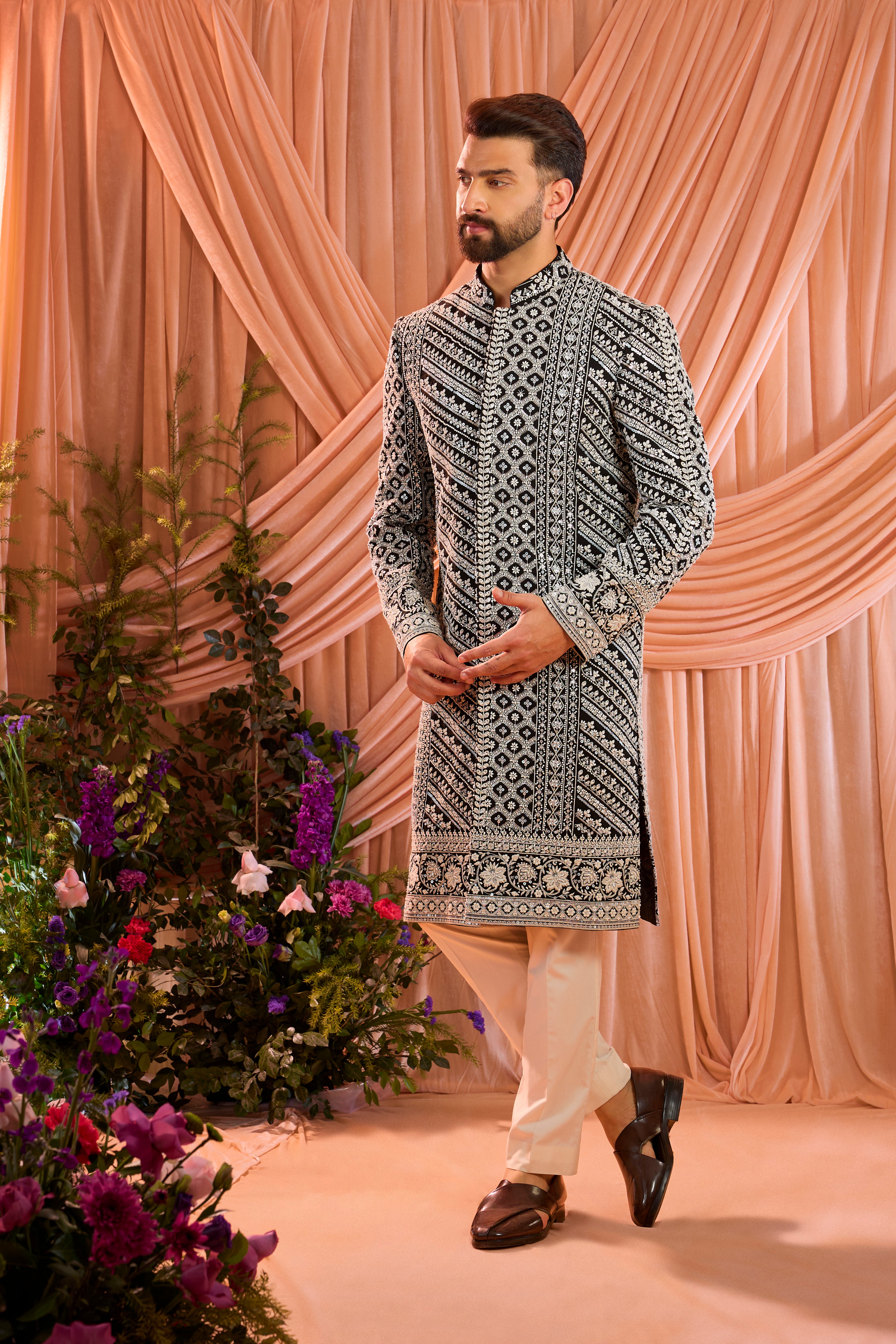 Black hand-embroidered formal sherwani , exquisitely adorned with intricate ivory cut-dana detailing.