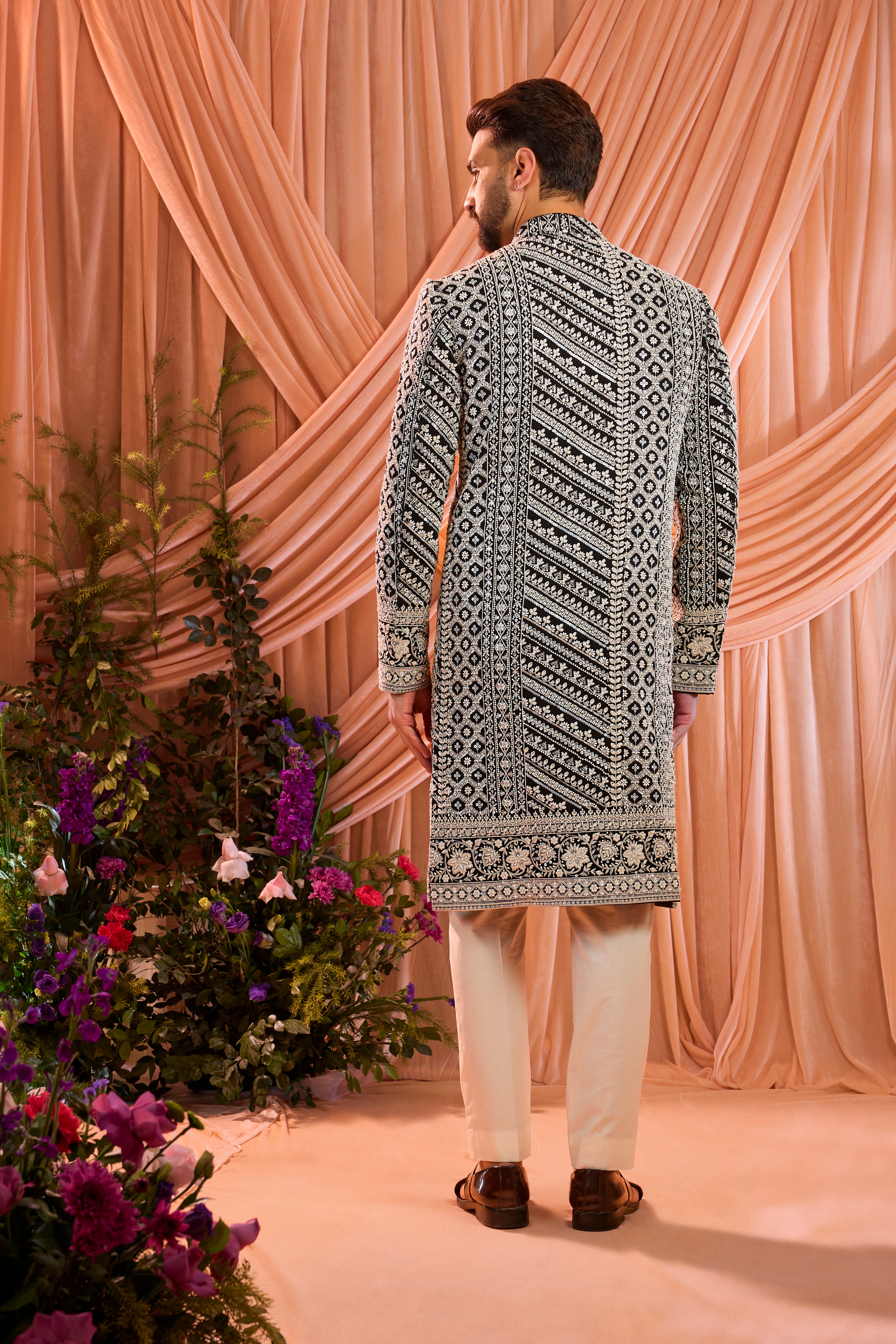 Black hand-embroidered formal sherwani , exquisitely adorned with intricate ivory cut-dana detailing.