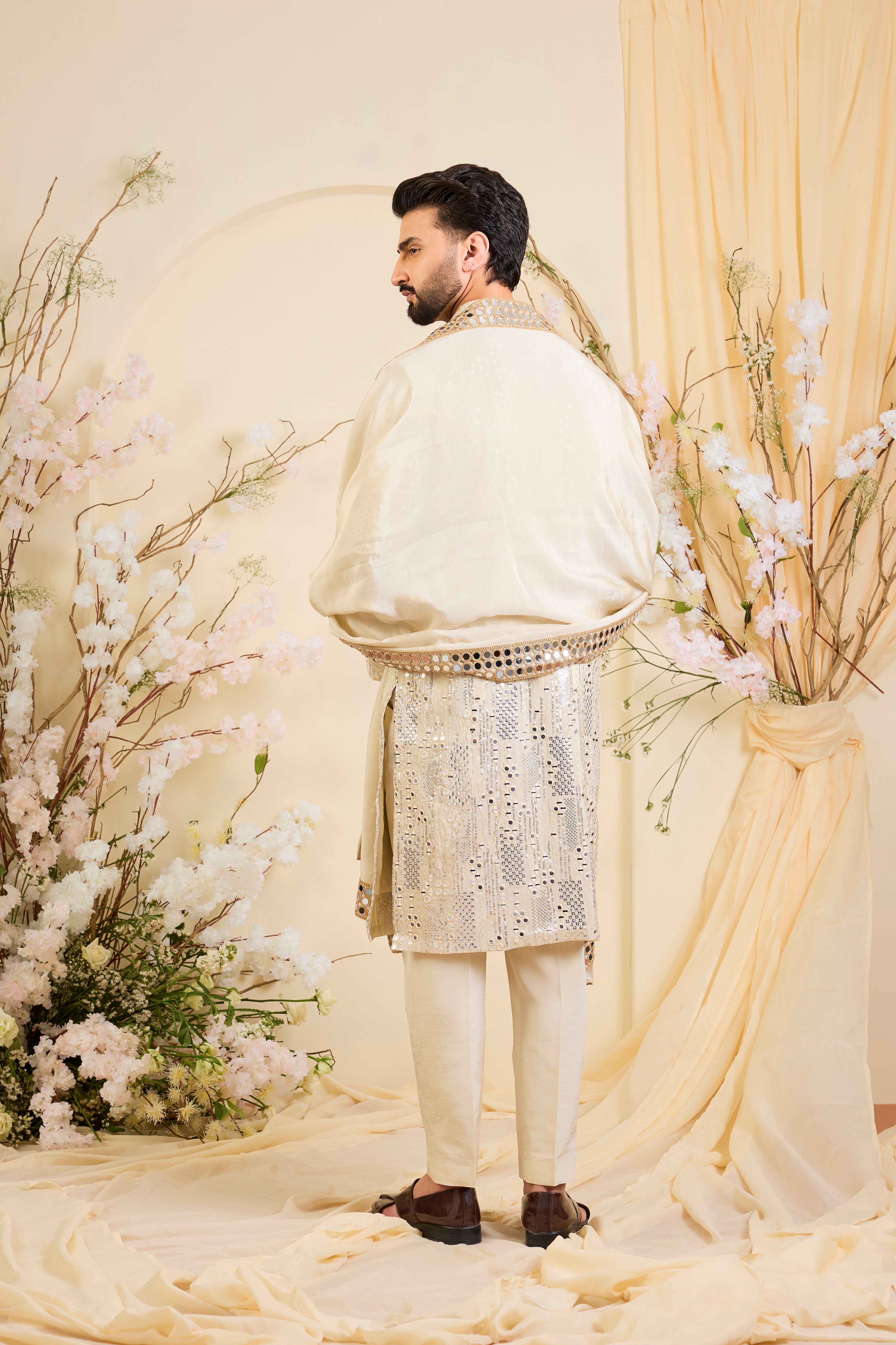 Golden tissue kurta with sequin mirrorwork, paired with a real mirror work stole and striking gold border — made to shine.