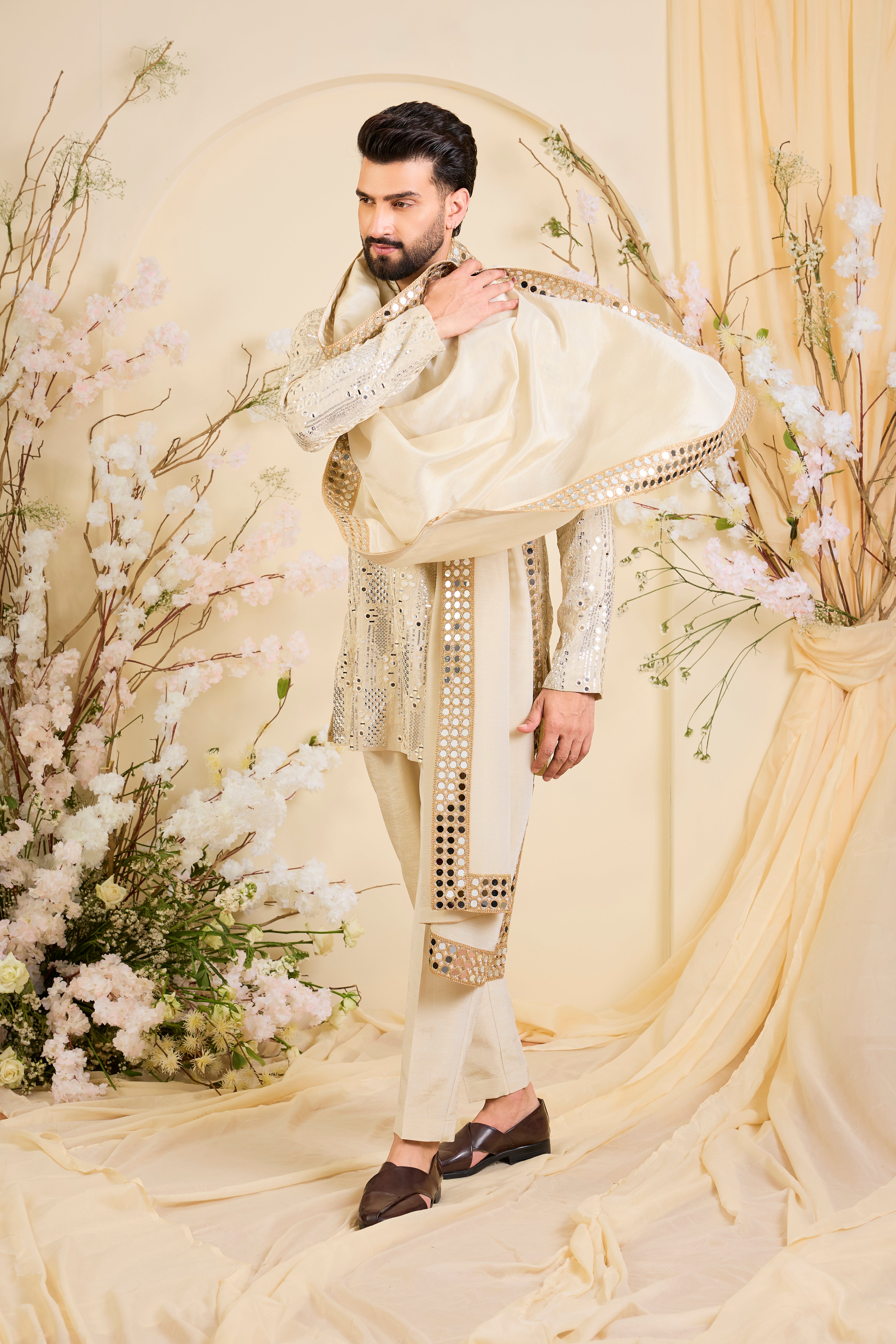 Golden tissue kurta with sequin mirrorwork, paired with a real mirror work stole and striking gold border — made to shine.