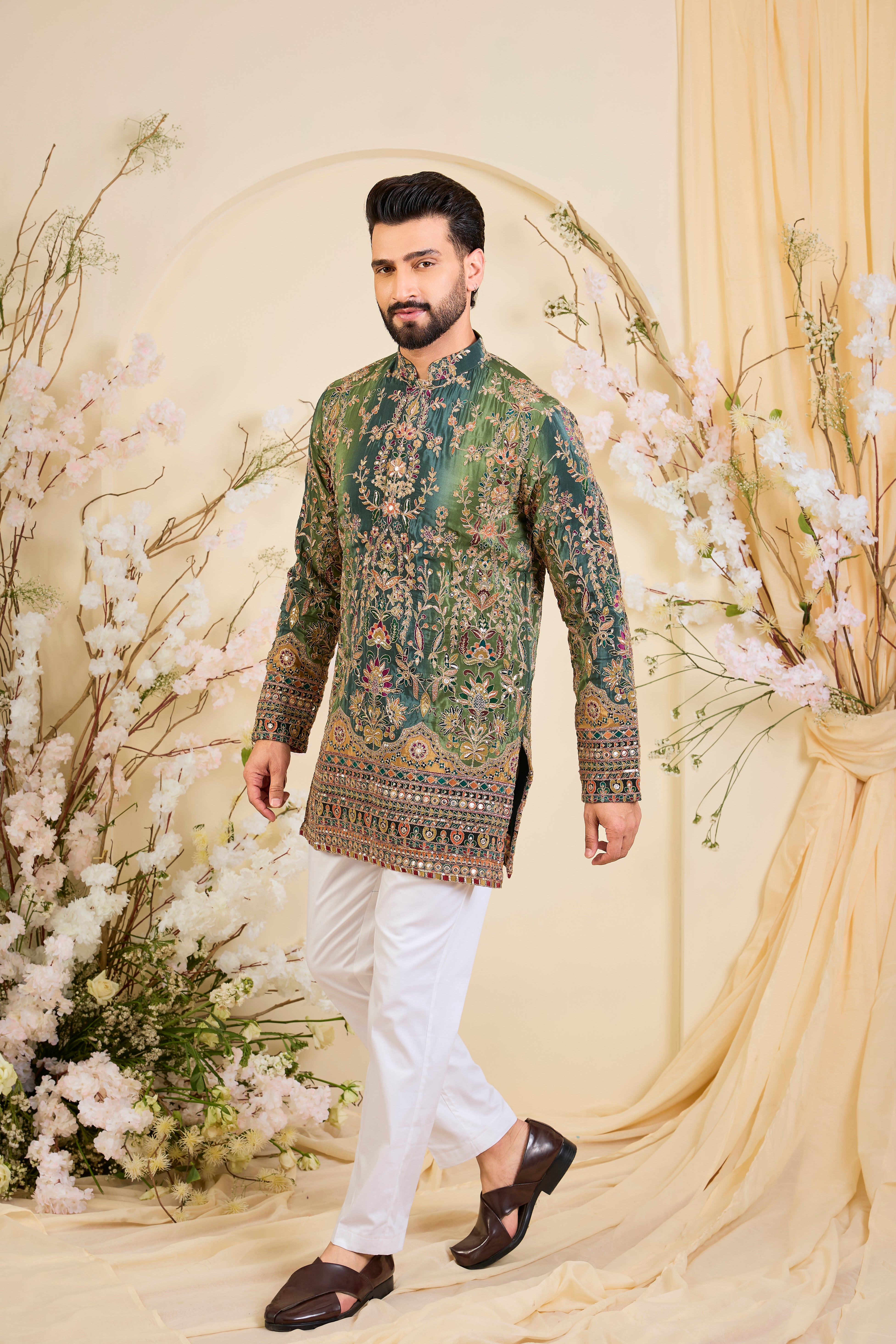 Green crepe short kurta with intricate zari work, vibrant multicolour prints, and refined sequin detailing.