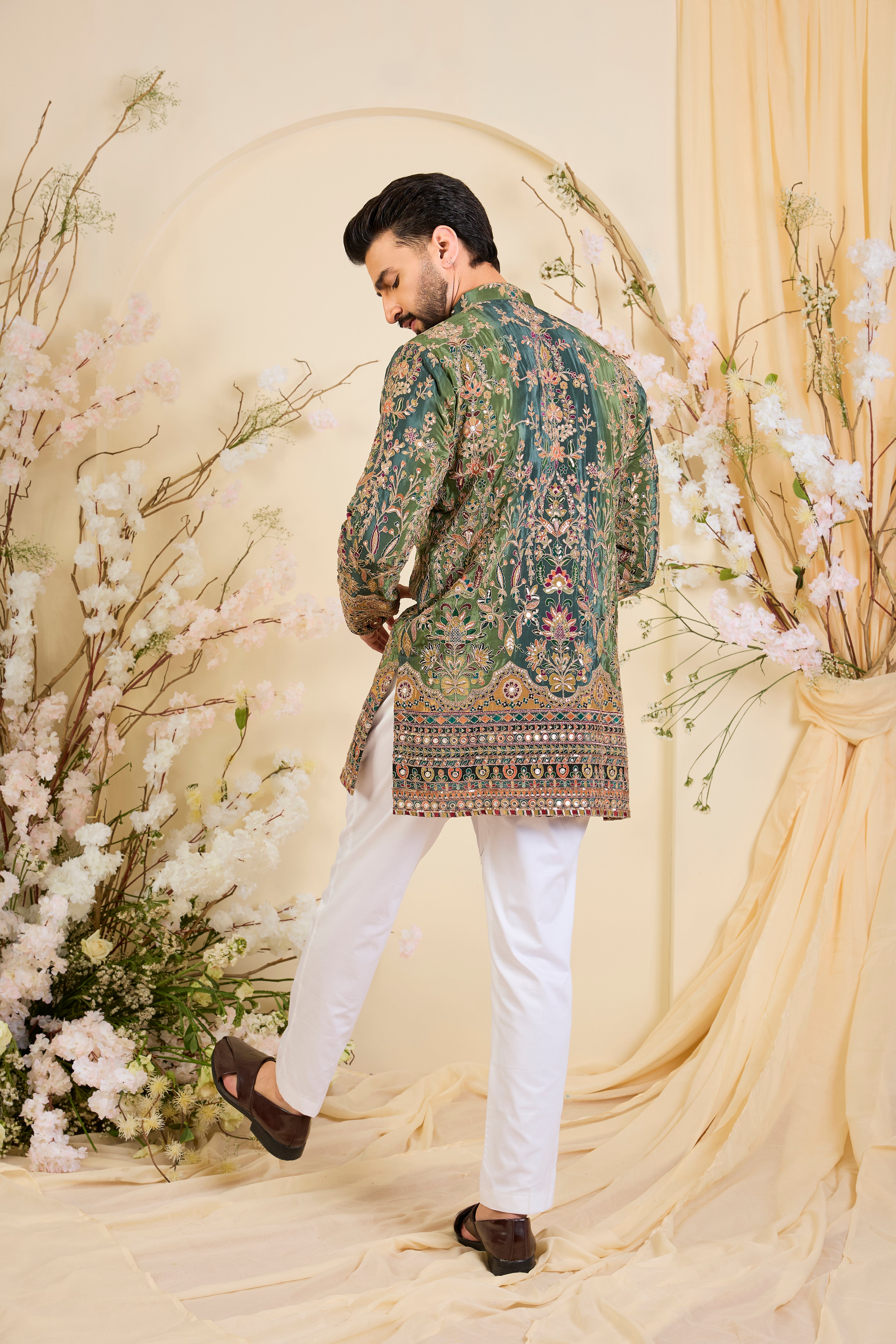 Green crepe short kurta with intricate zari work, vibrant multicolour prints, and refined sequin detailing.