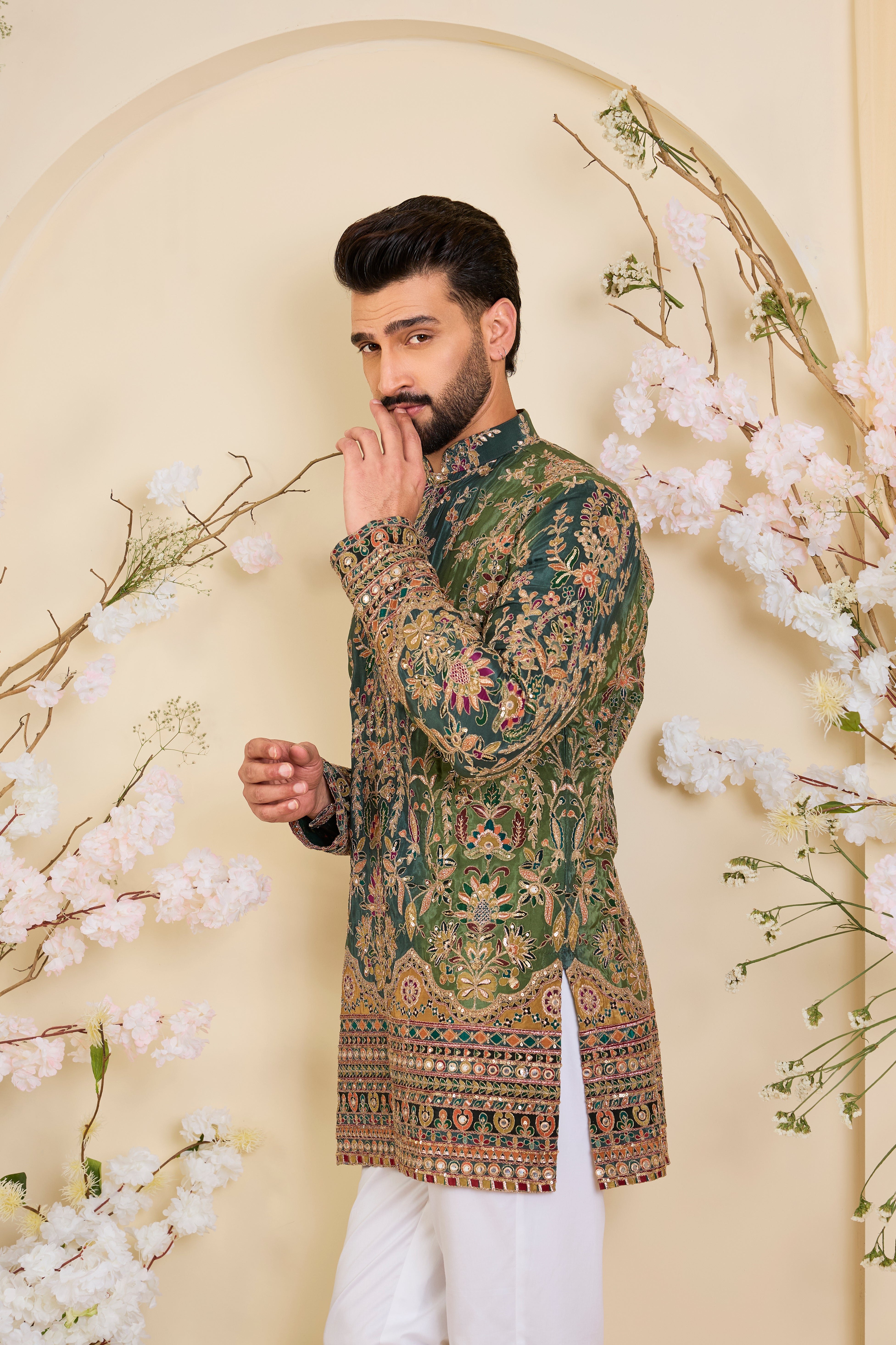 Green crepe short kurta with intricate zari work, vibrant multicolour prints, and refined sequin detailing.