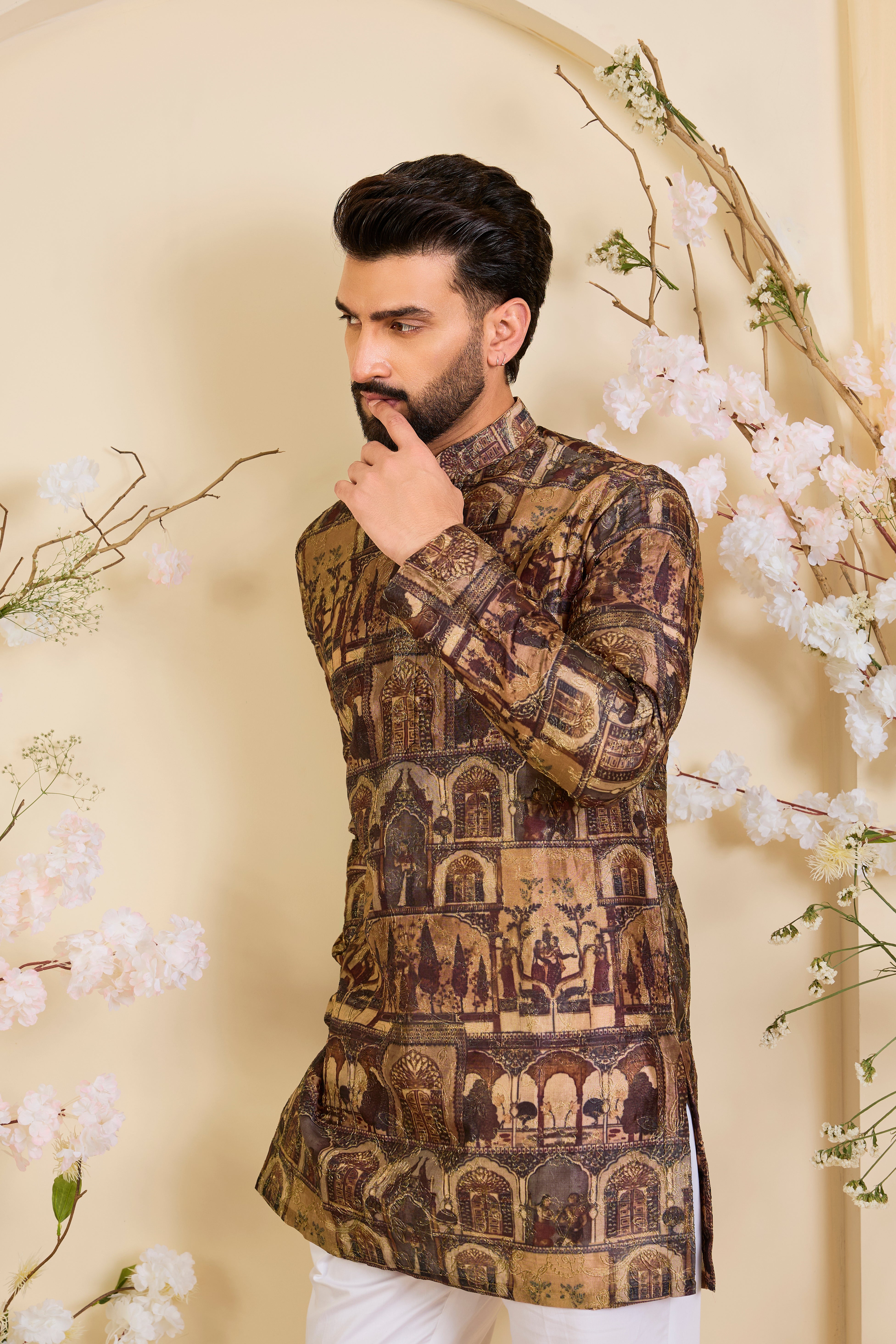 Brown kurta featuring detailed Mughal darbar scenes, enriched with intricate prints and fine aari embroidery. A tribute to royal heritage.