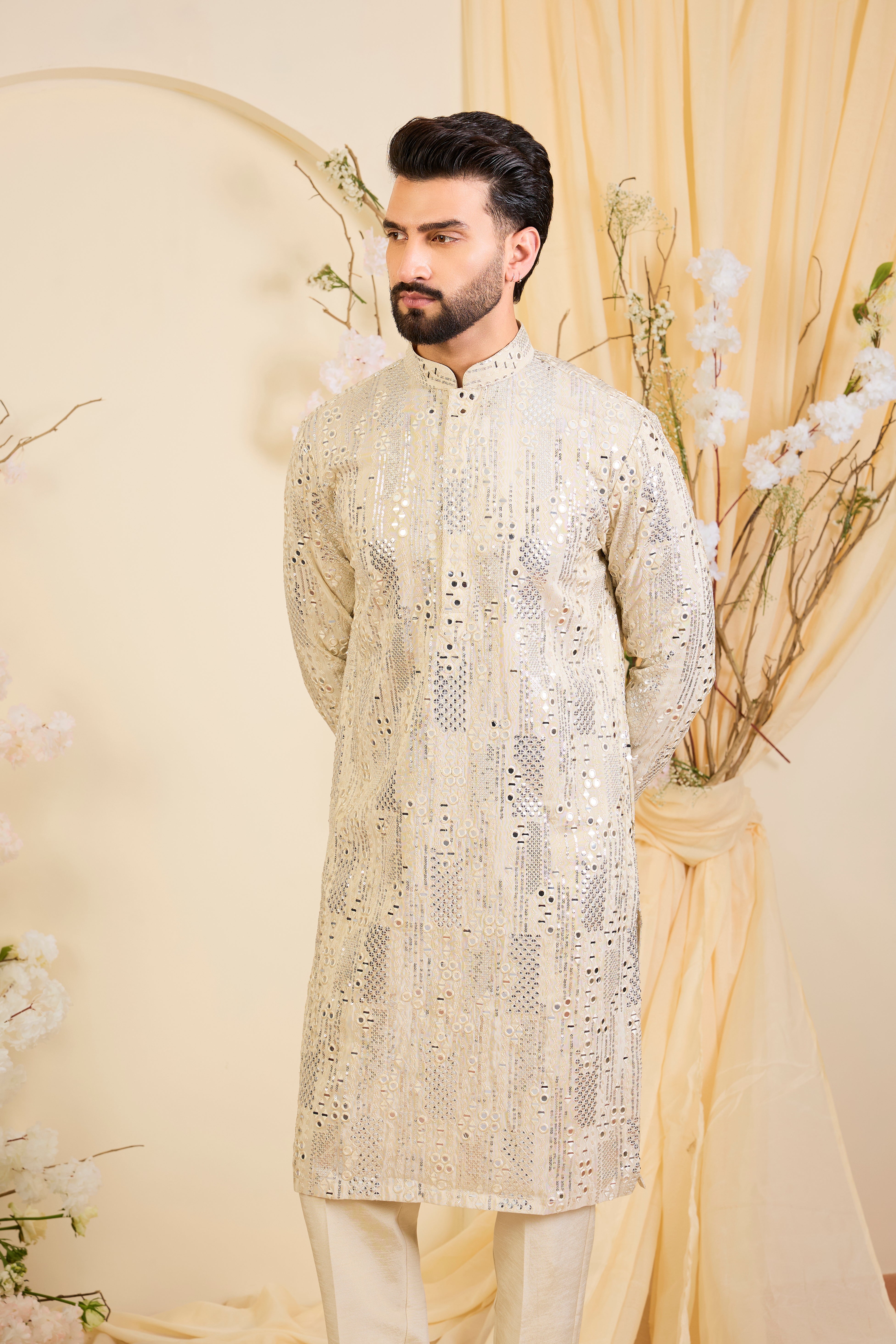 Golden tissue long kurta with intricate sequin mirrorwork and tone-on-tone threadwork. A luminous take on understated opulence.