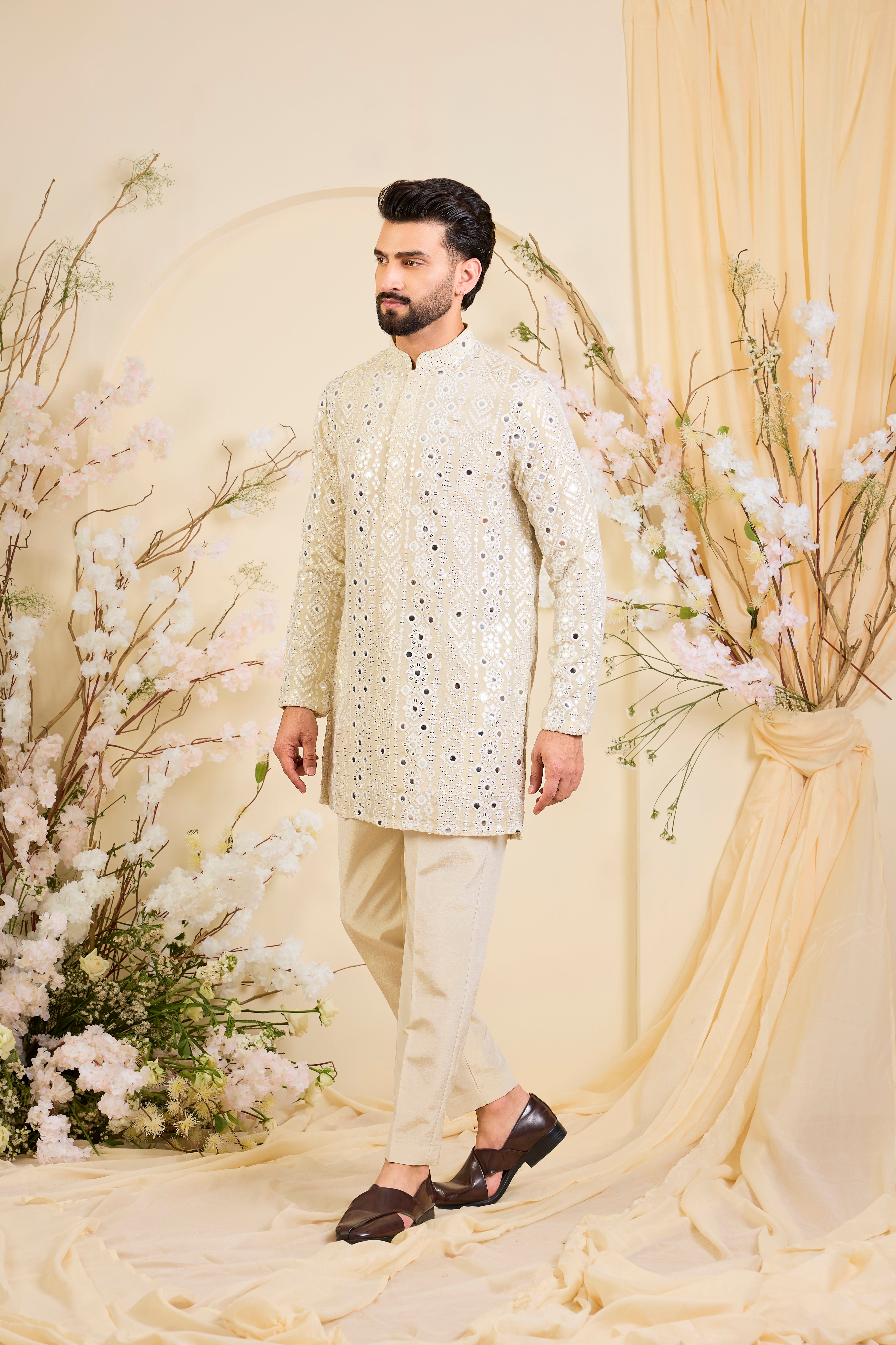 Golden tissue short kurta with intricate sequin mirrorwork and tone-on-tone threadwork. A luminous take on understated opulence.