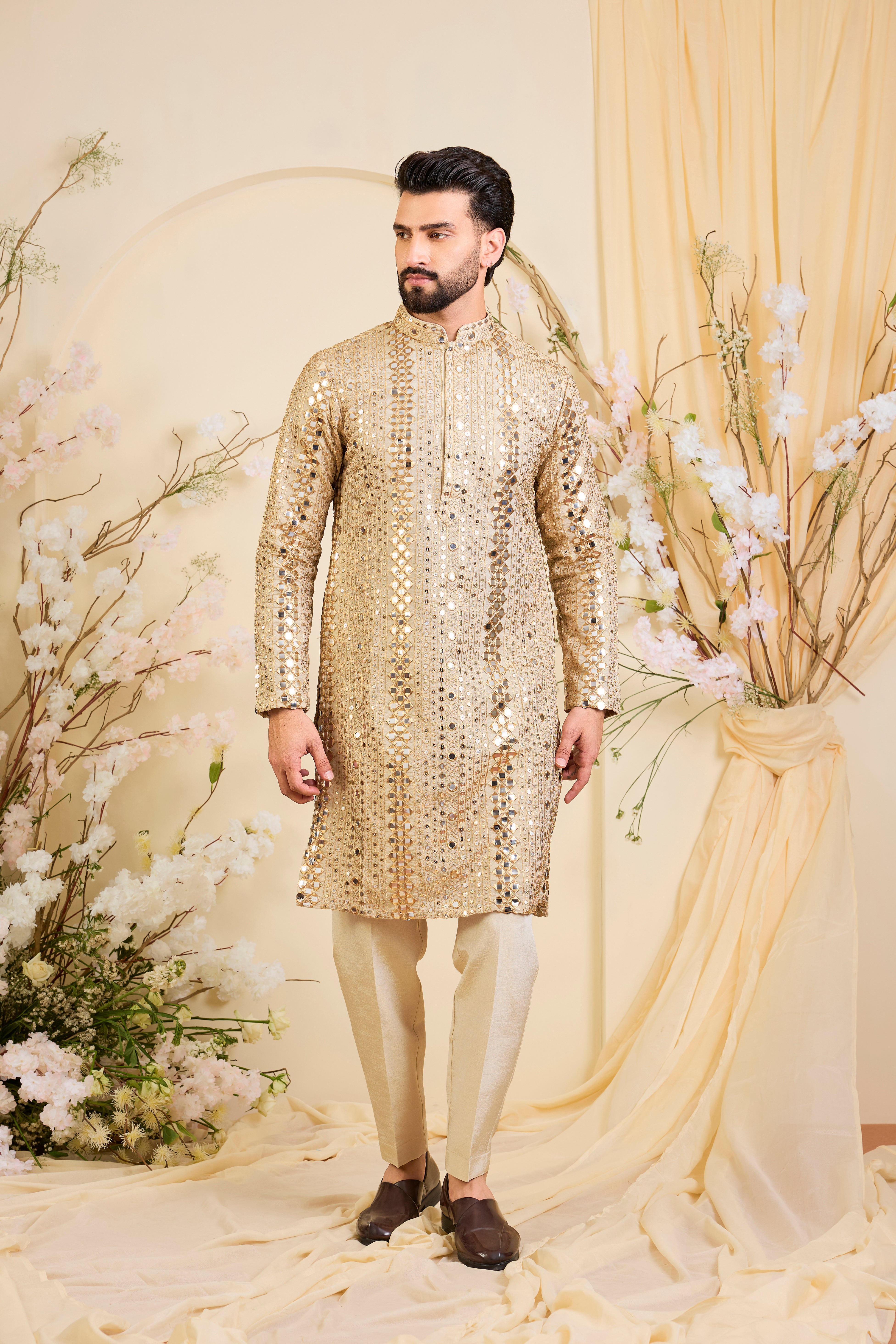 Golden tissue long kurta with intricate sequin mirrorwork and tone-on-tone threadwork. A luminous take on understated opulence.