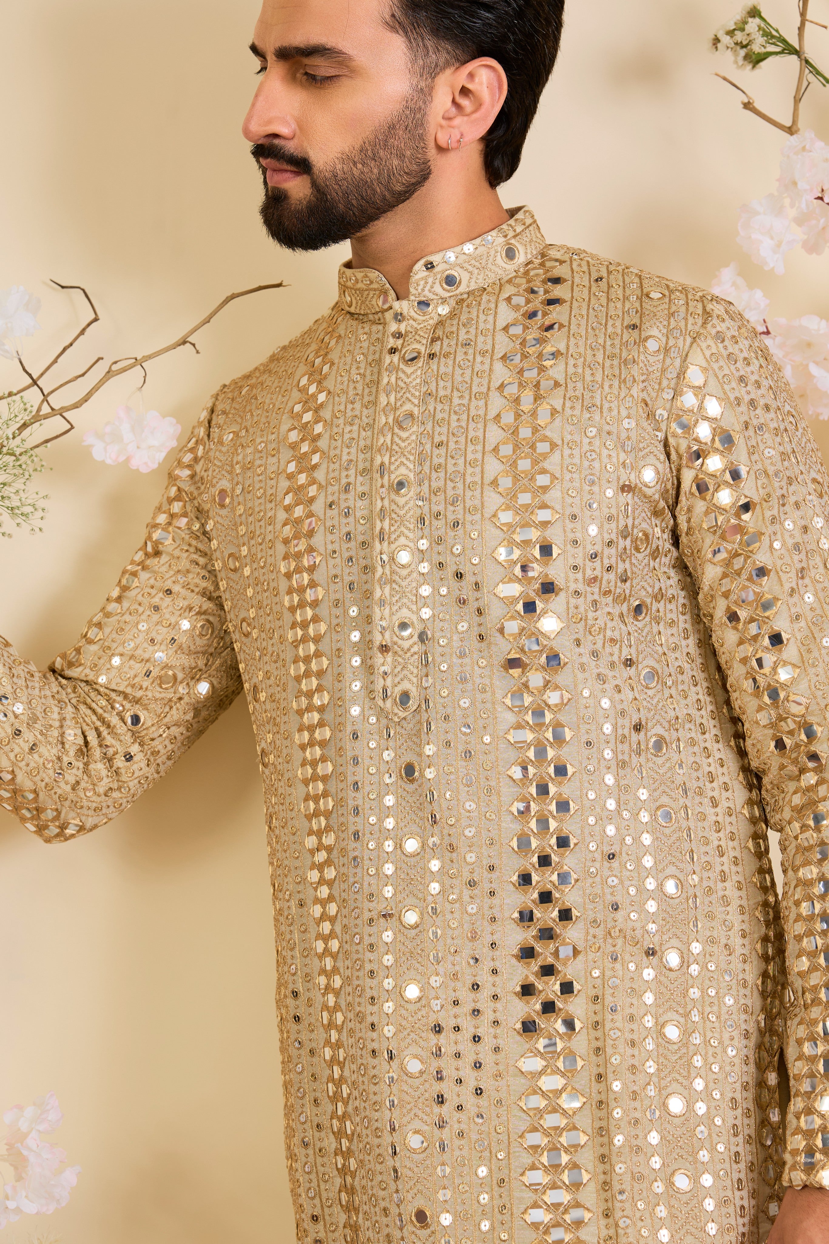 Golden tissue long kurta with intricate sequin mirrorwork and tone-on-tone threadwork. A luminous take on understated opulence.