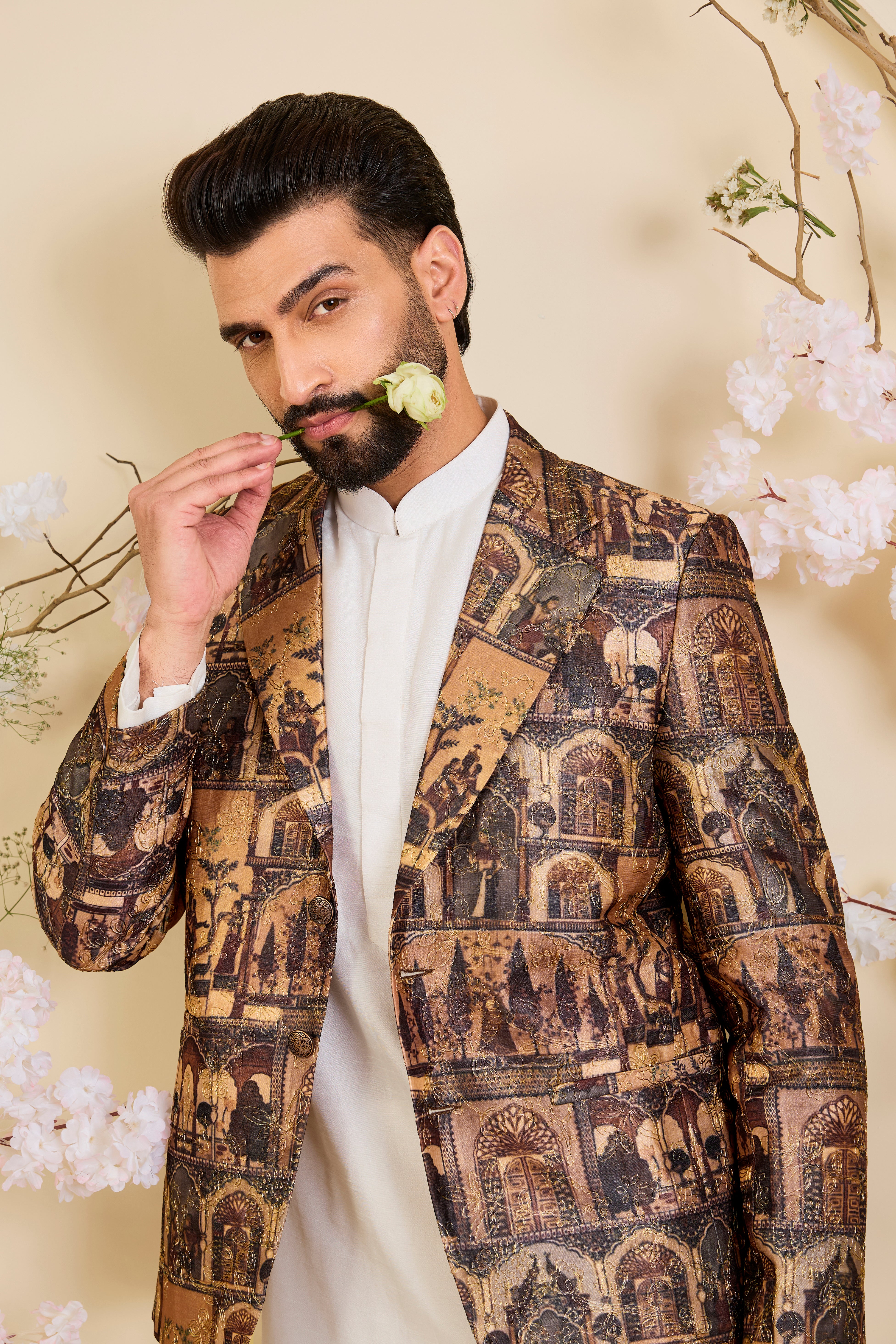 Brown blazer featuring detailed Mughal figures and courtly scenes, elevated with fine aari embroidery for a refined, heritage-rich expression.