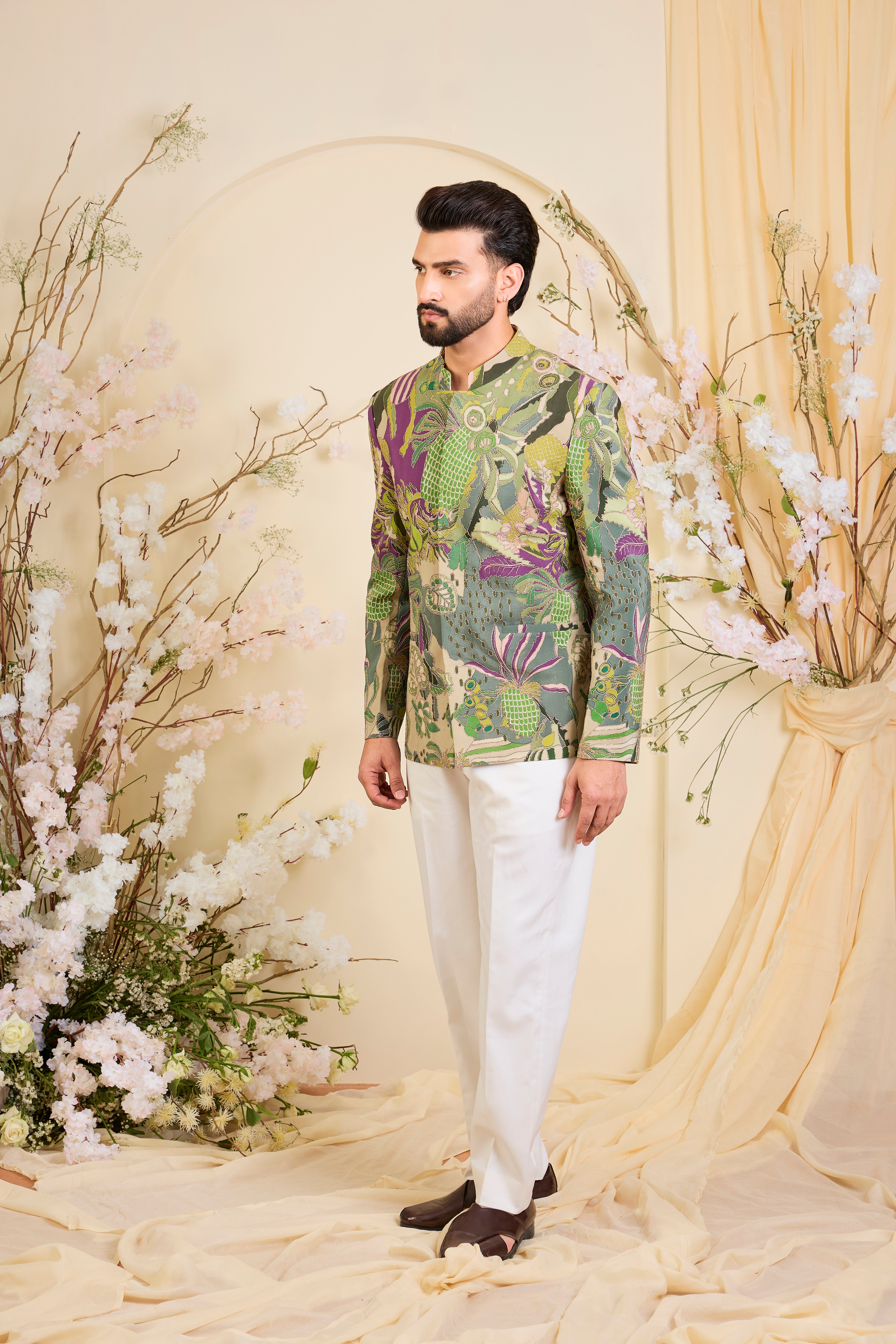 Green abstract bandhgala with detailed multicolour prints and intricate zari accents, blending artistic expression with refined, modern elegance.