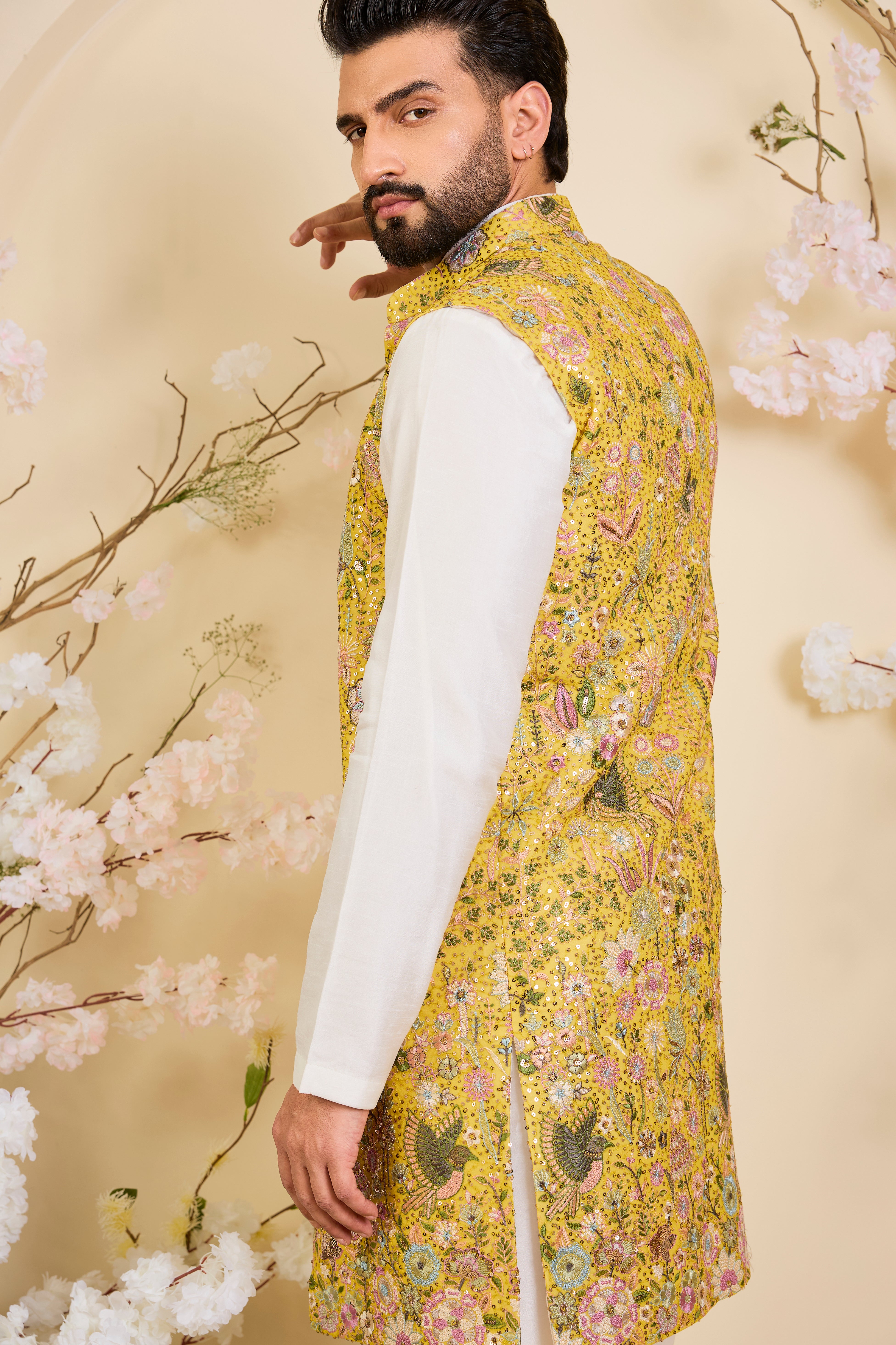 Yellow long open jacket with intricate sequin work and detailed flora-fauna motifs, offering a luminous, richly layered couture statement.