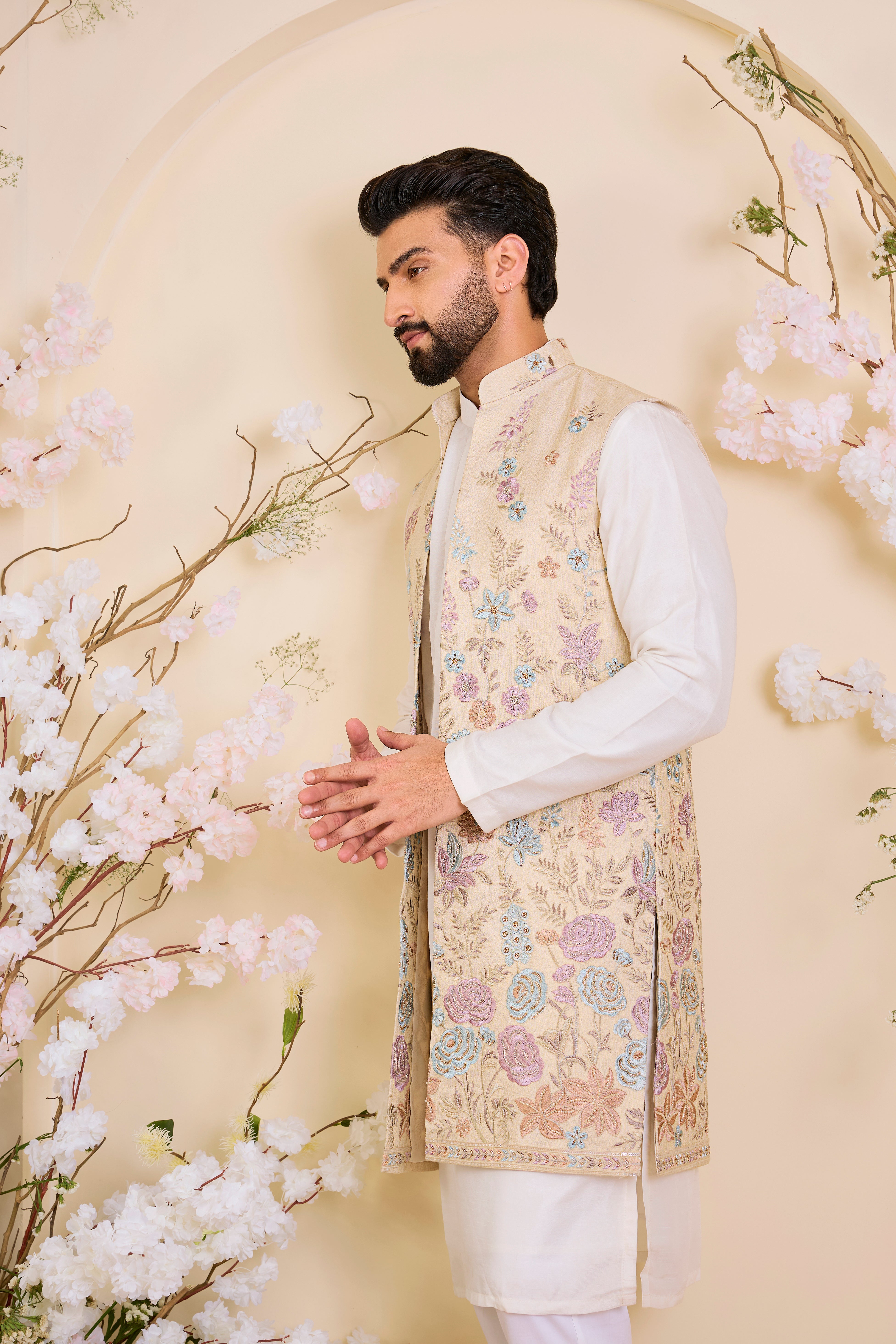Beige-gold long open jacket with intricate multicolour floral embroidery and delicate cut dana work, offering a refined, luminous couture statement.