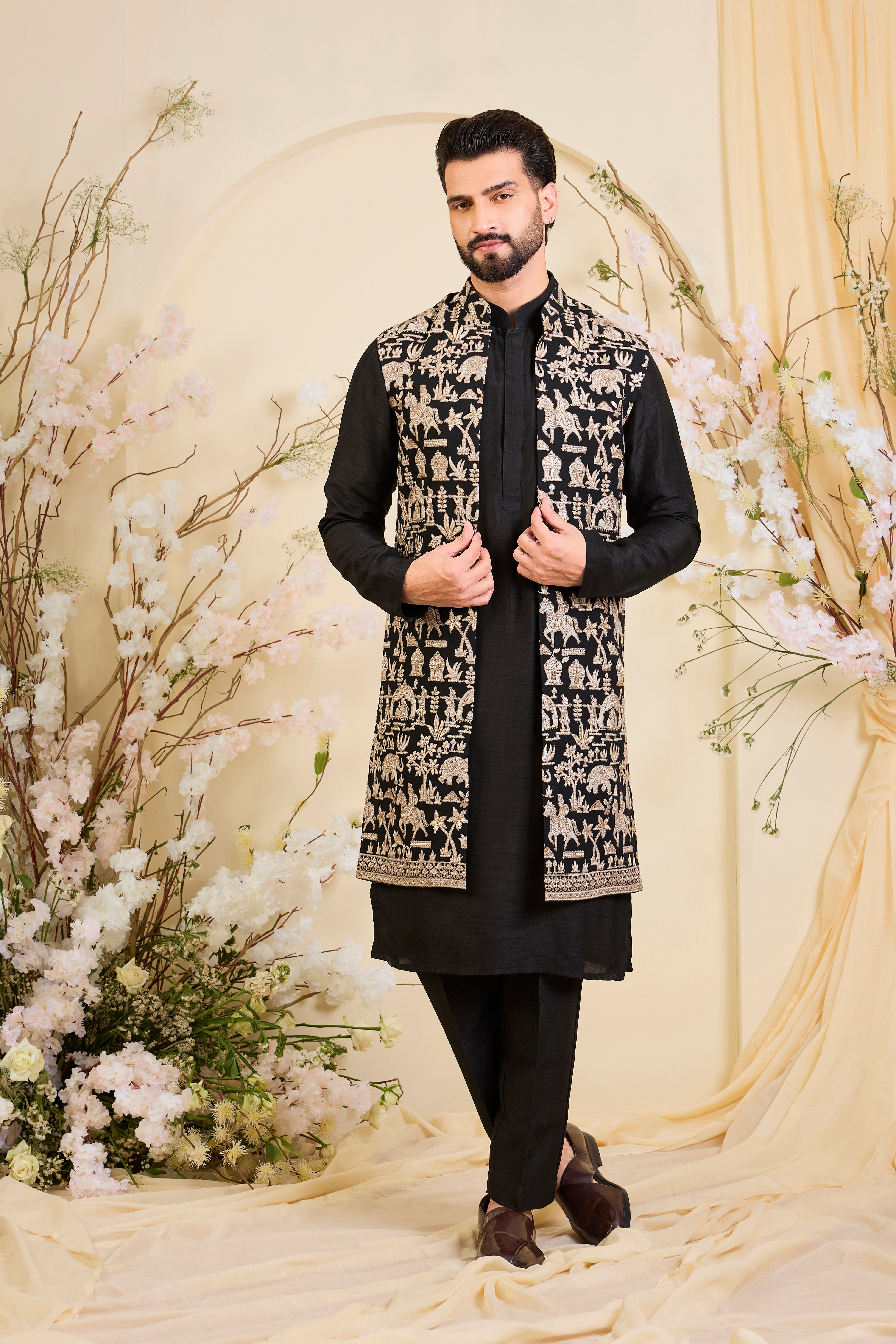 Black long open jacket with intricate zari work, sequin detailing, and Mughal-era embroidery, delivering a richly layered, regal couture statement.