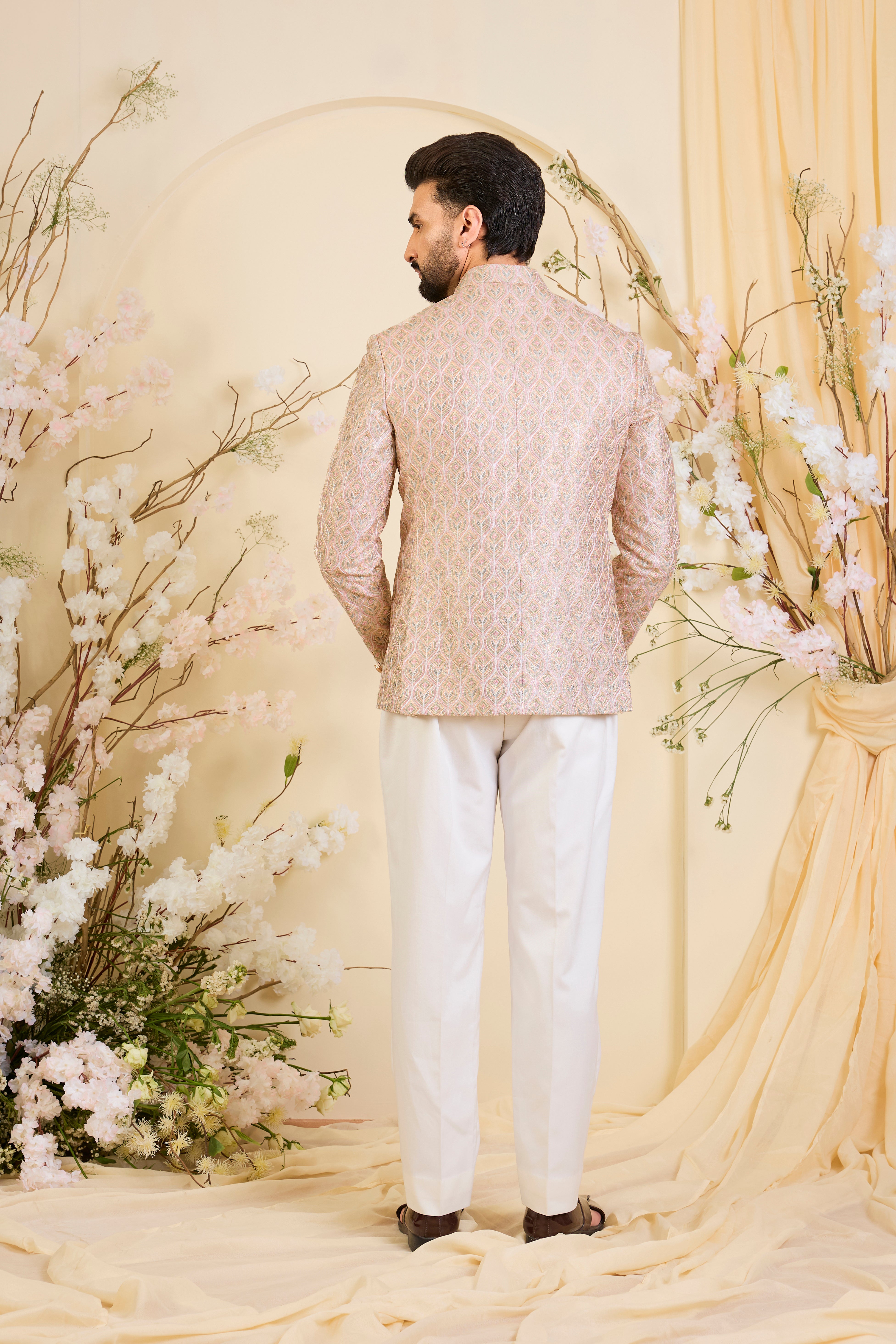 Multicoloured short bandhgala with intricate threadwork and delicate, light-catching zari detailing, offering a bold yet refined couture statement.