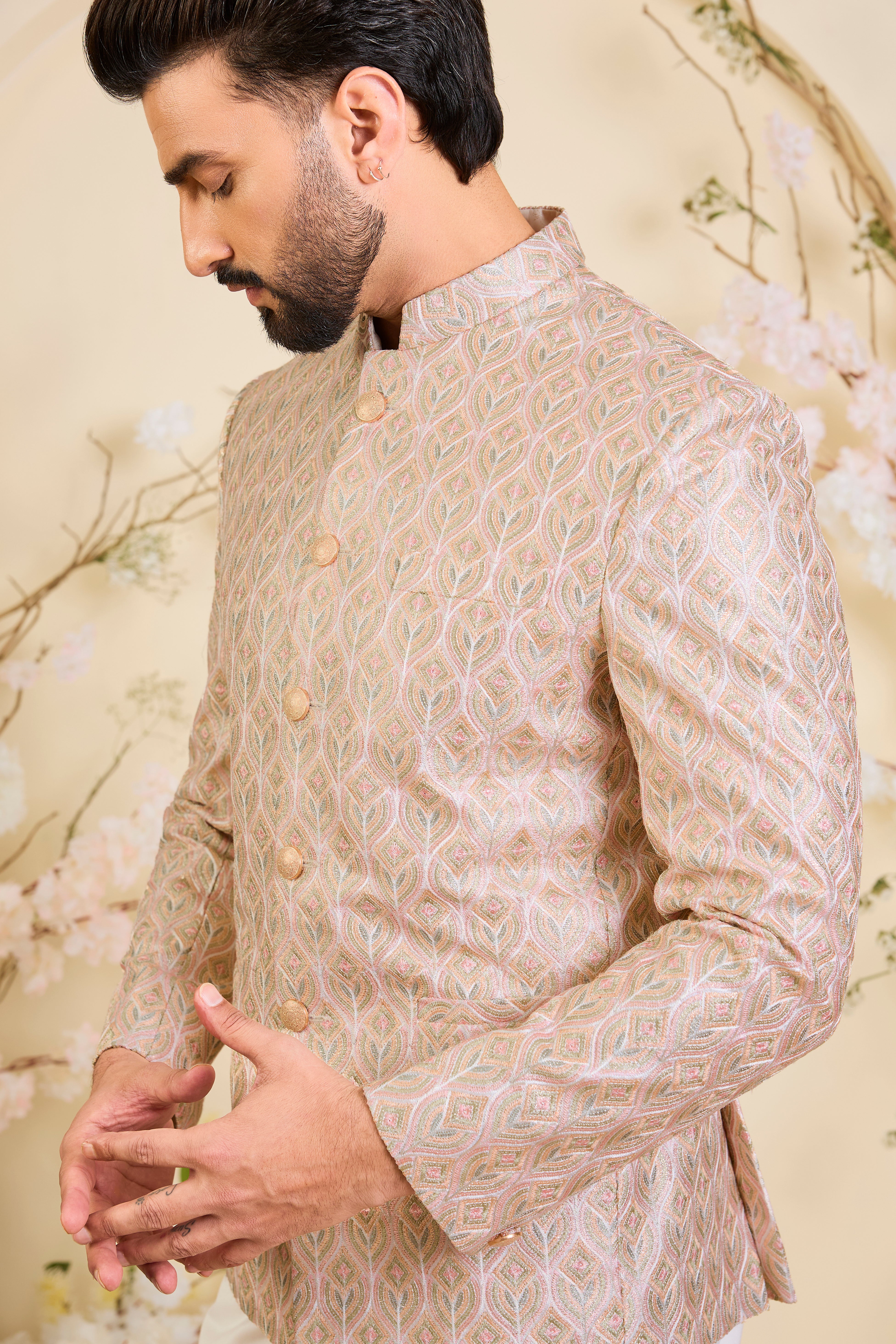 Multicoloured short bandhgala with intricate threadwork and delicate, light-catching zari detailing, offering a bold yet refined couture statement.