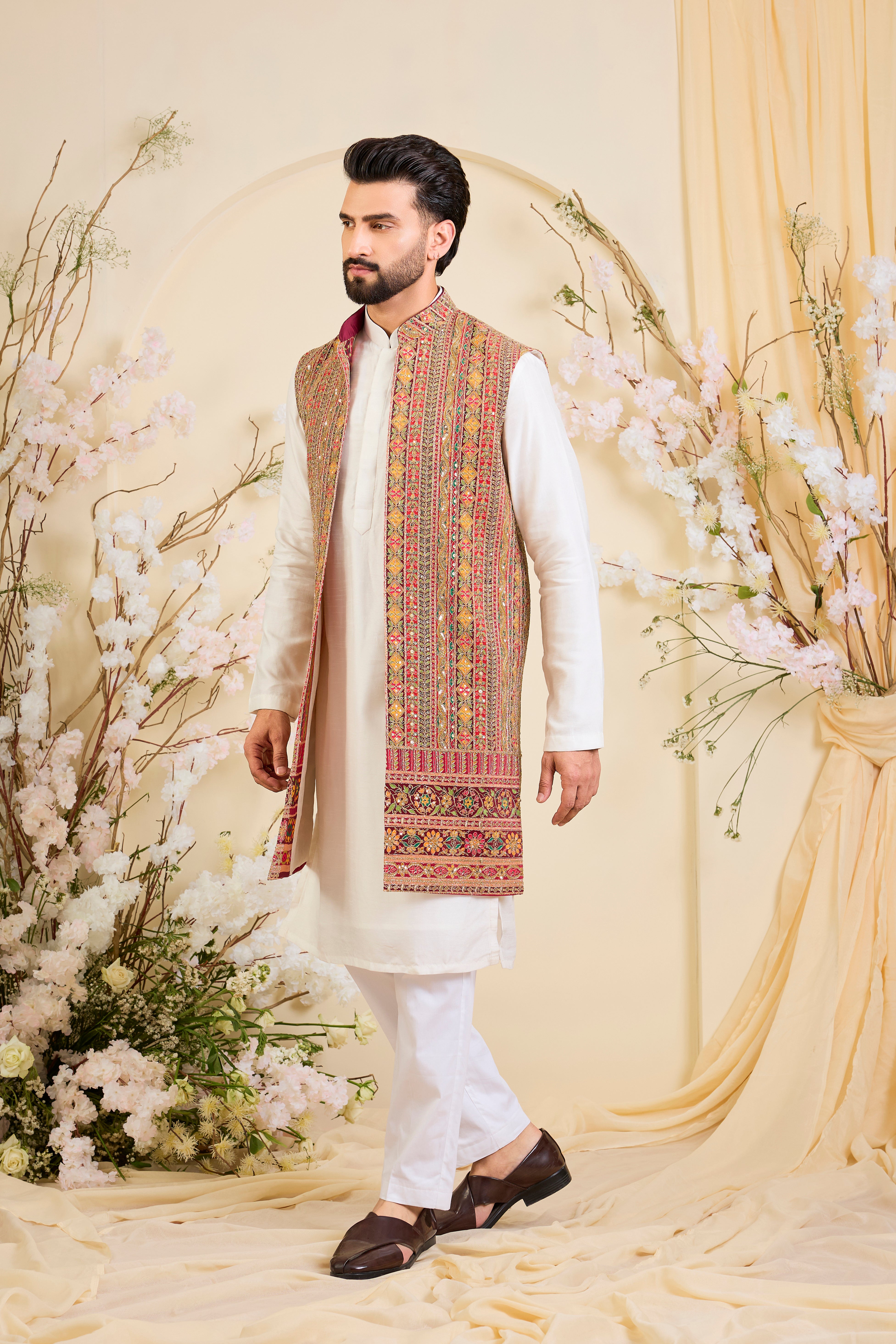 Pink base open long jacket with heavy zari embroidery, intricate sequins, and multicolour prints, crafted for bold, opulent, statement-making occasions.