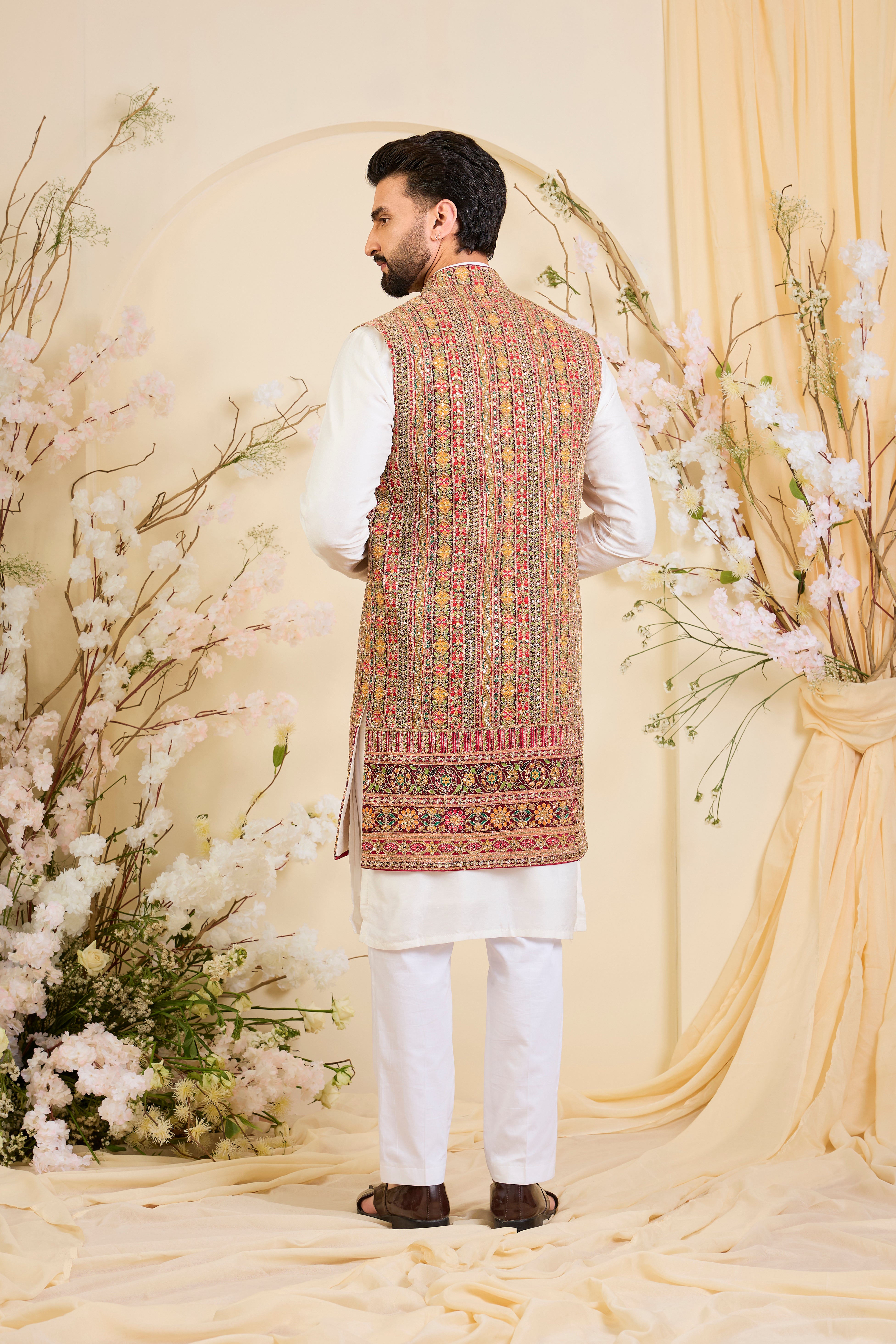 Pink base open long jacket with heavy zari embroidery, intricate sequins, and multicolour prints, crafted for bold, opulent, statement-making occasions.