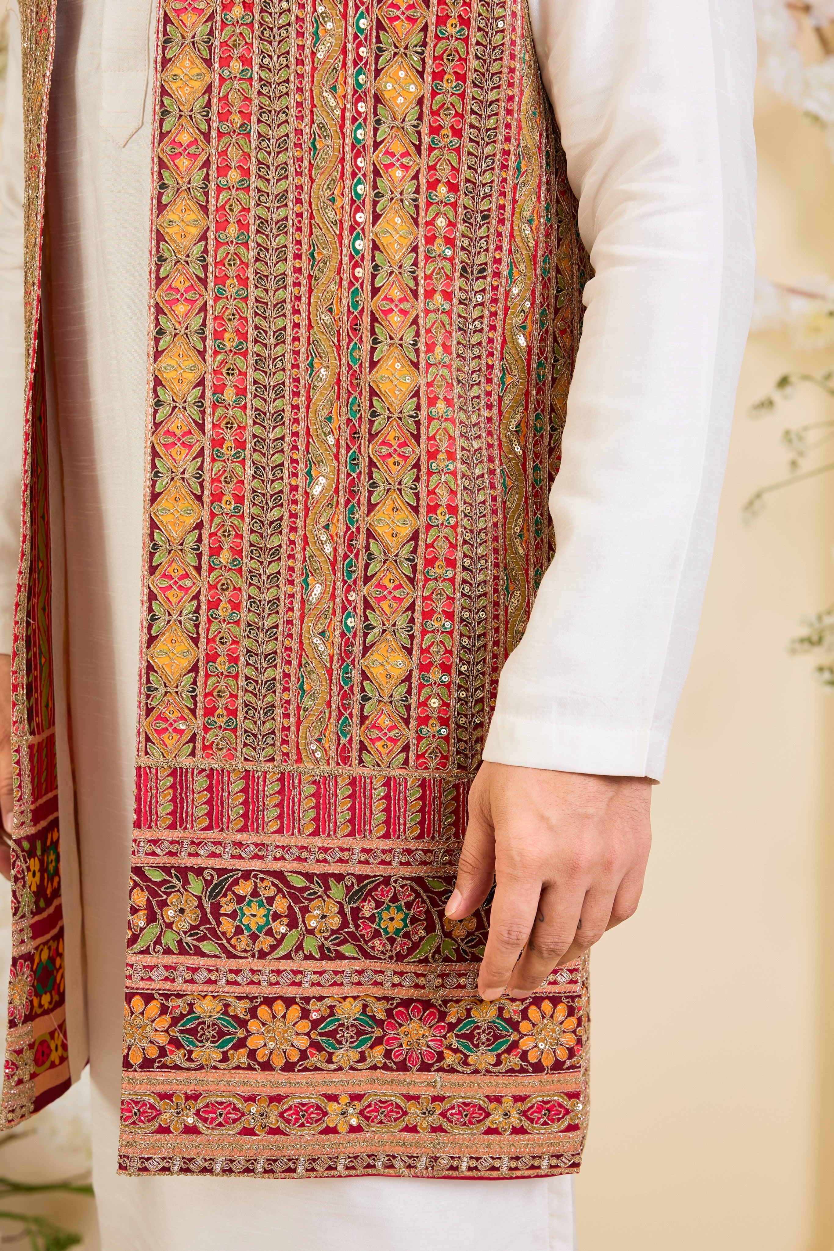 Pink base open long jacket with heavy zari embroidery, intricate sequins, and multicolour prints, crafted for bold, opulent, statement-making occasions.