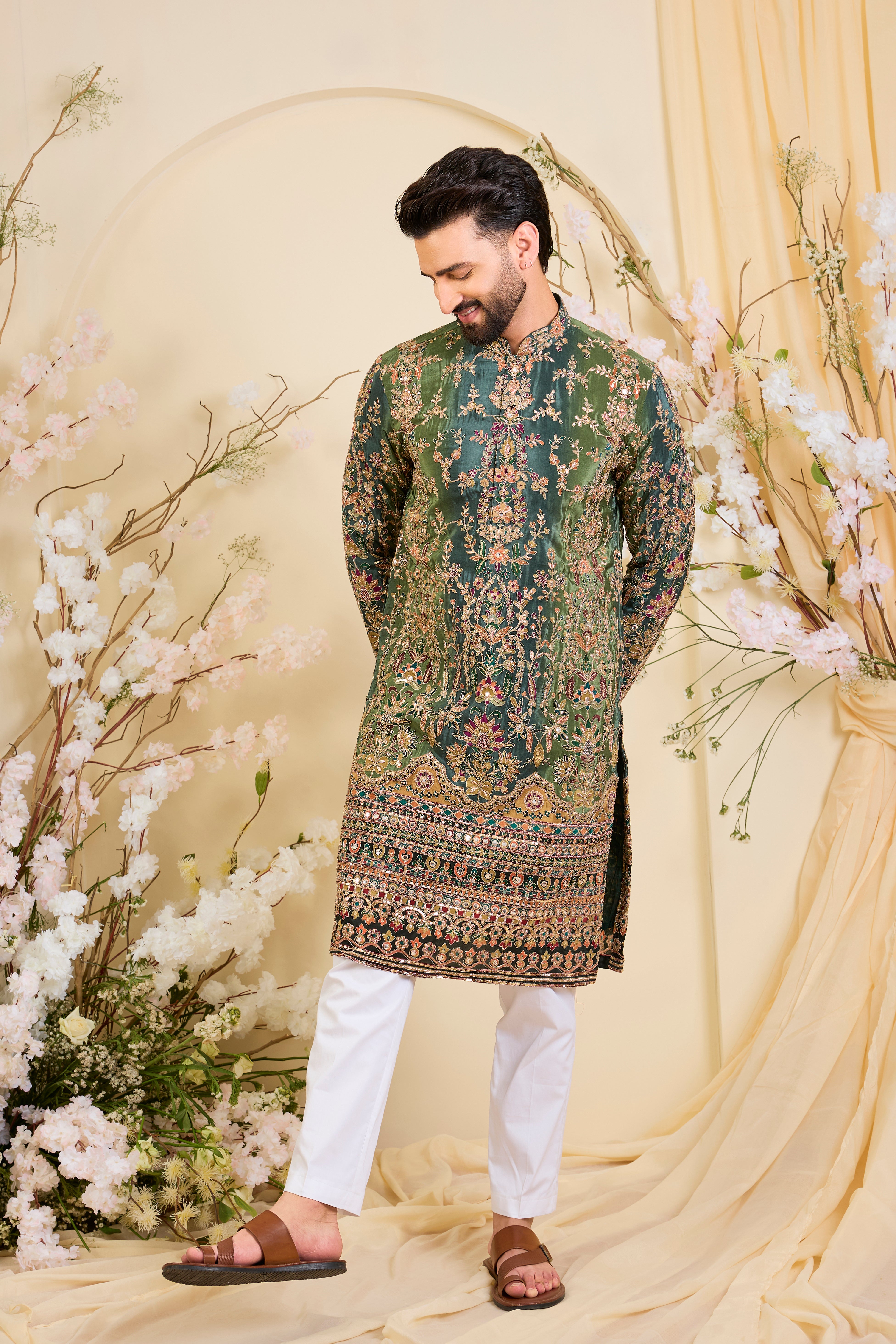 Green crepe kurta with intricate zari work, vibrant multicolour prints, and refined sequin detailing.