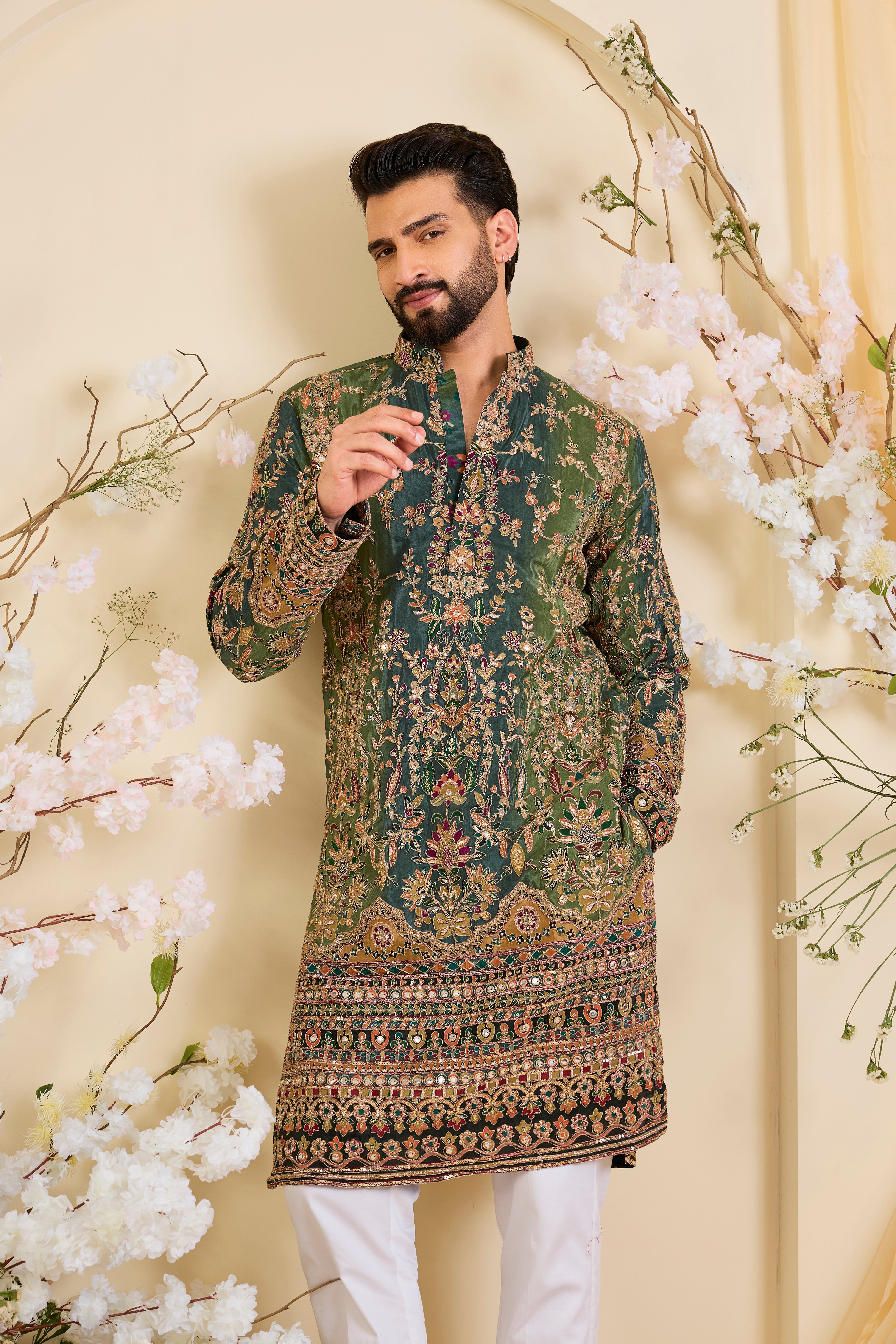 Green crepe kurta with intricate zari work, vibrant multicolour prints, and refined sequin detailing.