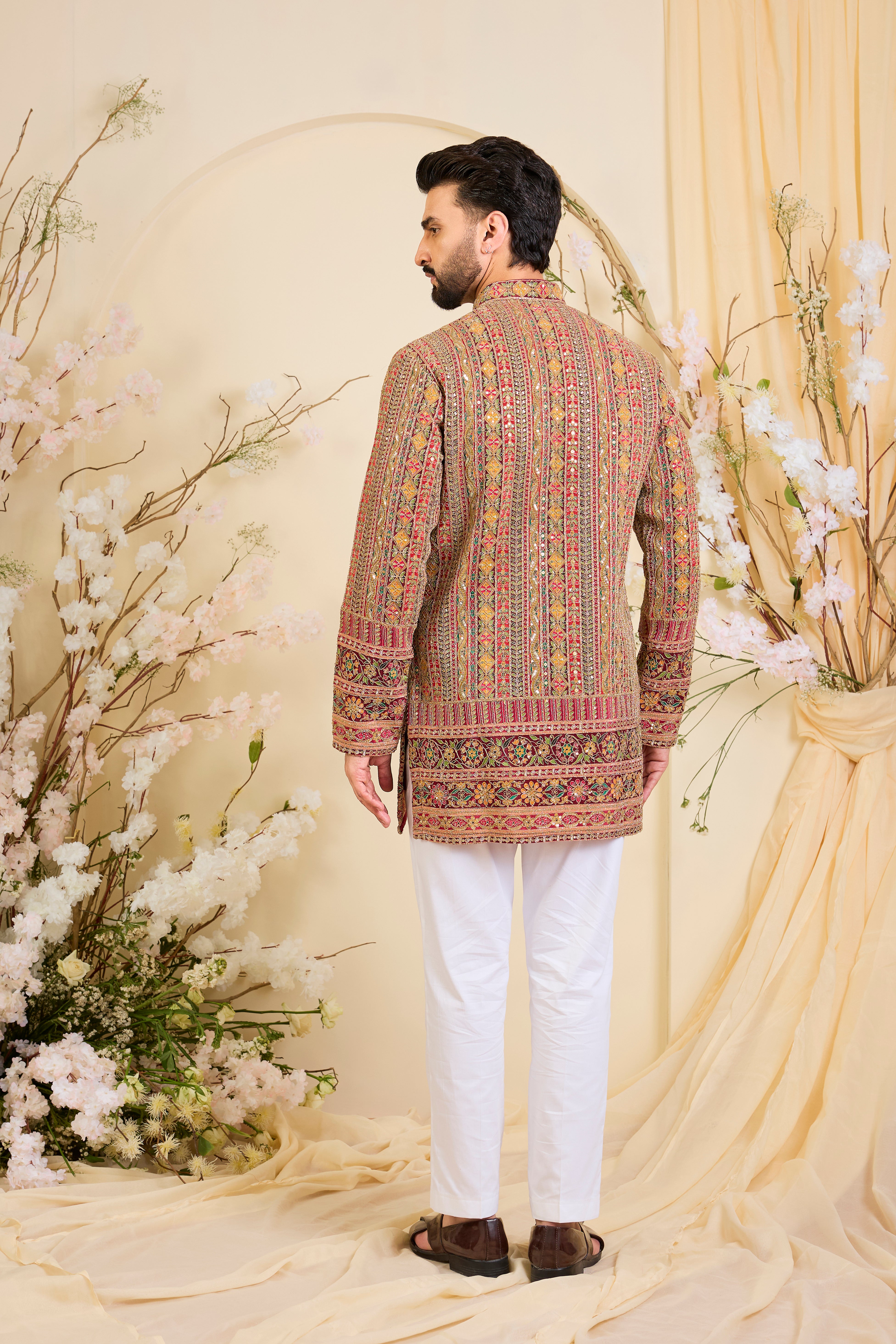 Pink base short kurta with heavy zari embroidery, intricate sequins, and multicolour prints, crafted for bold, opulent, statement-making occasions.